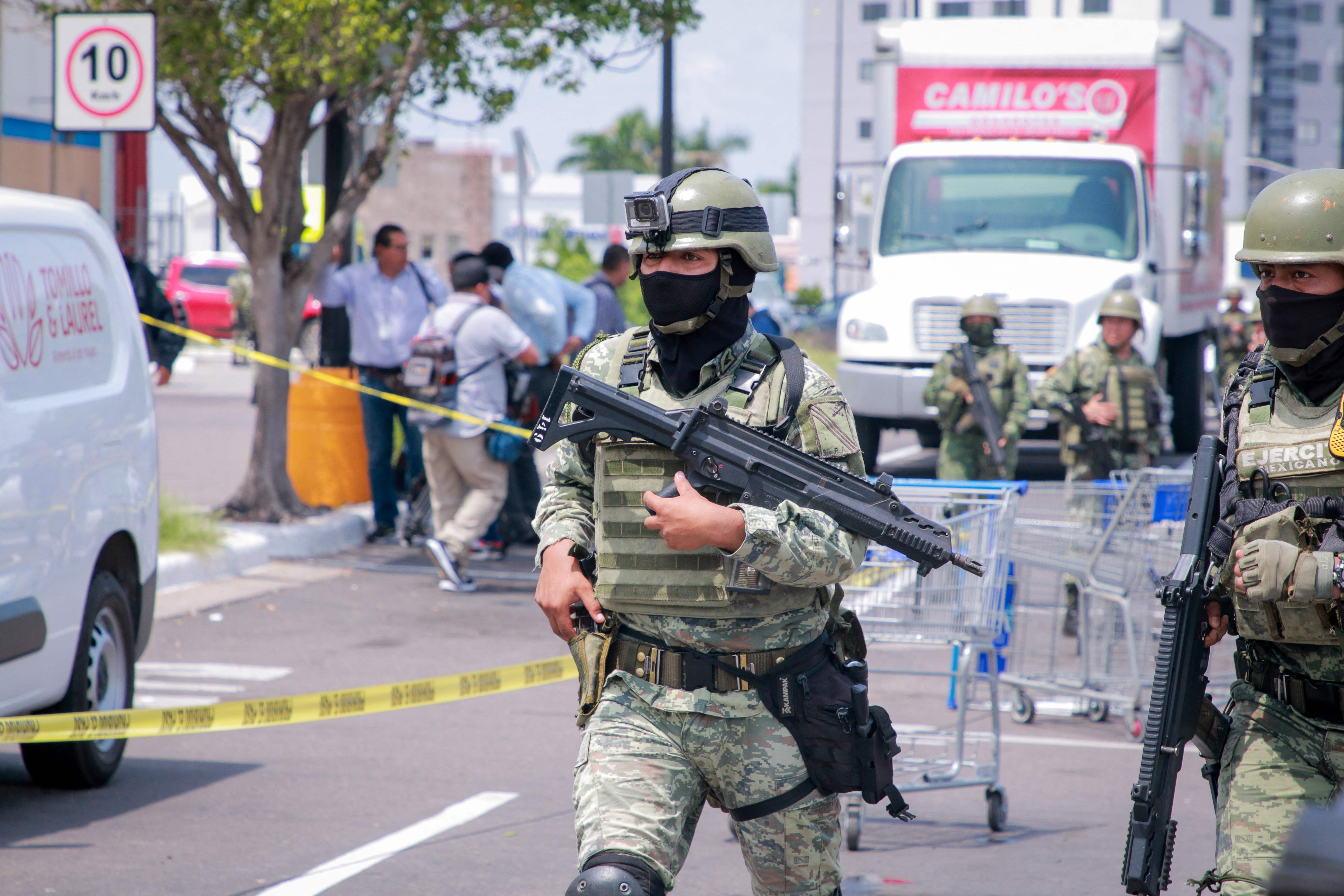 EDITORS NOTE: Graphic content / Members of the Mexican Army are seen in the car park of a shop where the body of a man was found in the Montebello neighborhood of Culiacán, Sinaloa State, Mexico, on September 12, 2024. Spiraling criminal violence, much of it linked to drug trafficking and gangs, has seen more than 450,000 people murdered in Mexico since 2006. (Photo by Ivan MEDINA / AFP)