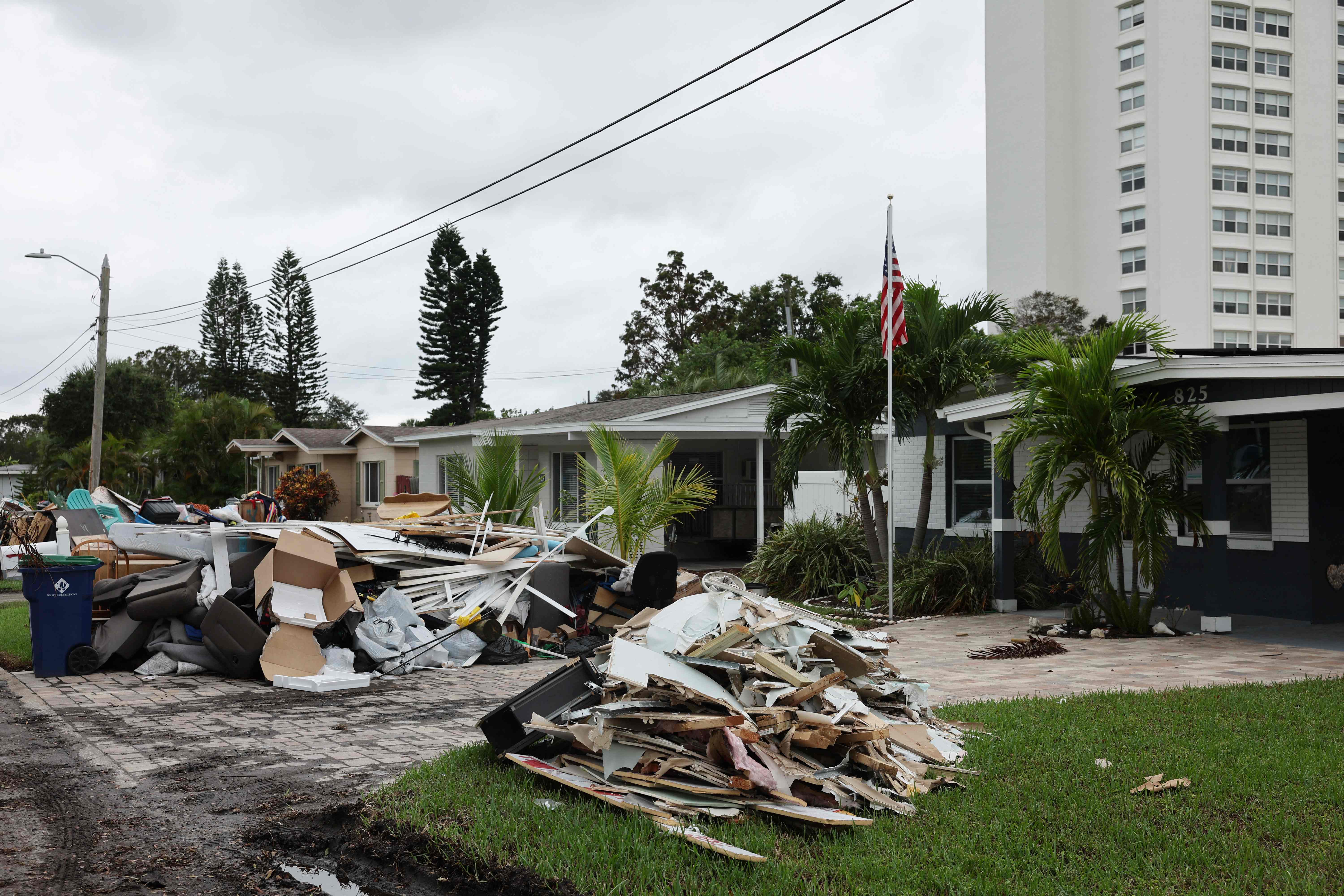 TREASURE ISLAND, FLORIDA - OCTOBER 07: Debris is piled up from the previous storm as preparations are made for Hurricane Milton's arrival on October 07, 2024, in Treasure Island, Florida. Milton, which came just after the recent catastrophic hurricane Helene, has strengthened to a Category 5 storm as it approaches Floridas Gulf Coast and is expected to make landfall midweek.   Spencer Platt/Getty Images/AFP (Photo by SPENCER PLATT / GETTY IMAGES NORTH AMERICA / Getty Images via AFP)