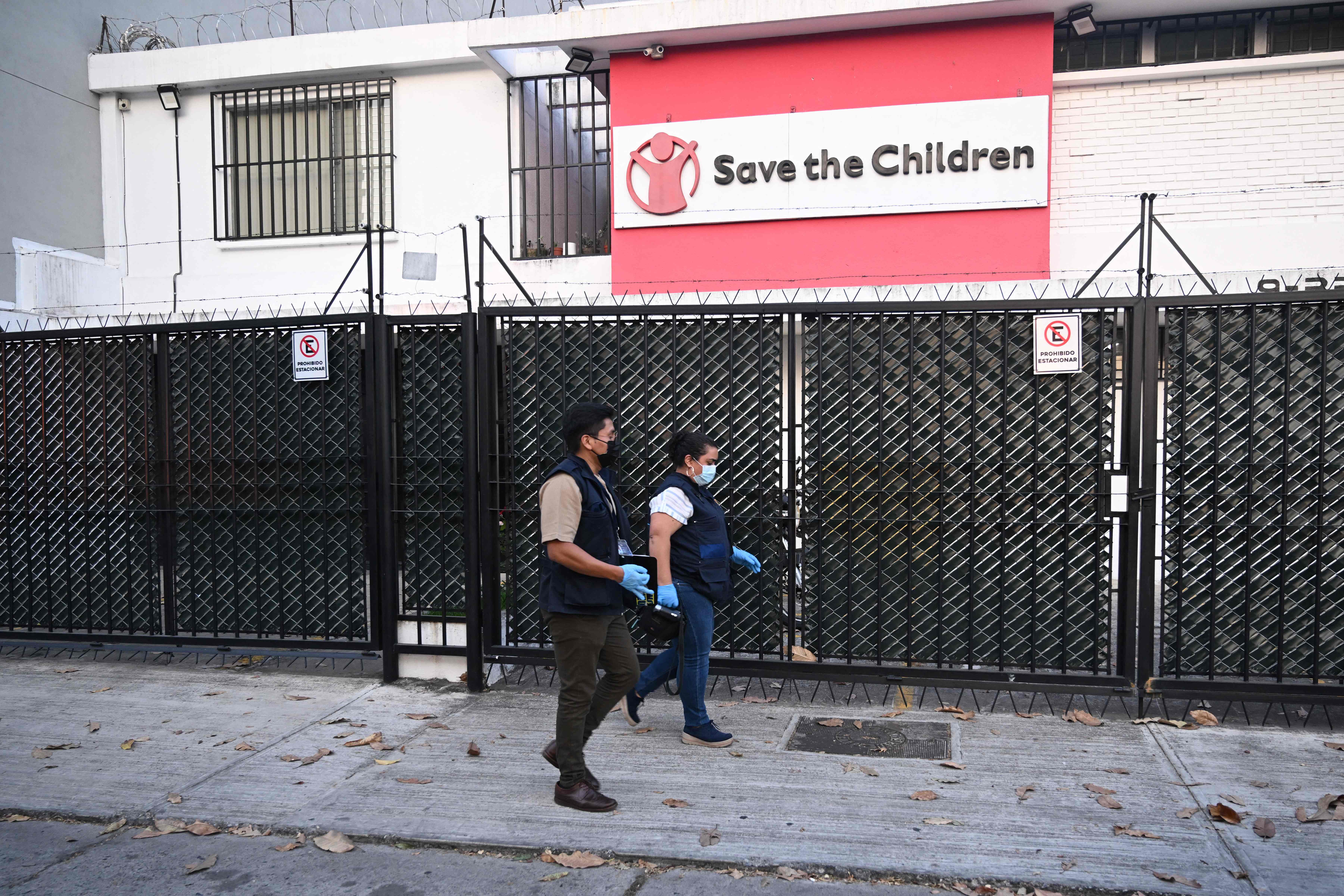 (FILES) Public prosecutors enter the offices of the NGO Save the Children during a raid in Guatemala City on April 25, 2024. The Guatemalan prosecutors office raided five regional offices of the NGO Save the Children on October 7 in a case of alleged child abuse, almost six months after they searched its office in the capital, the organisation said. (Photo by JOHAN ORDONEZ / AFP)