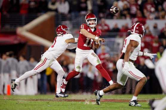 NORMAN, OKLAHOMA - NOVEMBER 23: Quarterback Jackson Arnold #11 of the Oklahoma Sooners throws under pressure from cornerback Domani Jackson #1 of the Alabama Crimson Tide in the fourth quarter at Gaylord Family Oklahoma Memorial Stadium on November 23, 2024 in Norman, Oklahoma. Oklahoma won 24-3.   Brian Bahr/Getty Images/AFP (Photo by BRIAN BAHR / GETTY IMAGES NORTH AMERICA / Getty Images via AFP)