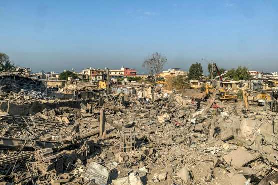 Men walk through the rubble at the site of an Israeli airstrike targeting the Ouzai neighborhood near Beirut International Airport in the citys southern suburbs on November 7, 2024. Israel launched fresh strikes on south Beirut early November 7, hours after Prime Minister Benjamin Netanyahu and US president-elect Donald Trump spoke about the "Iranian threat". (Photo by AFP)