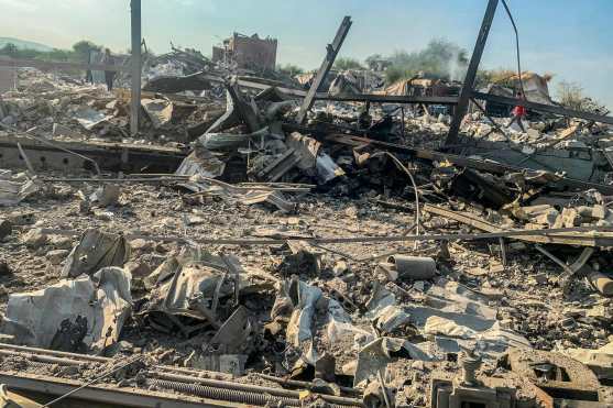 Men walk through the rubble at the site of an Israeli airstrike targeting the Ouzai neighborhood near Beirut International Airport in the citys southern suburbs on November 7, 2024. Israel launched fresh strikes on south Beirut early November 7, hours after Prime Minister Benjamin Netanyahu and US president-elect Donald Trump spoke about the "Iranian threat". (Photo by AFP)