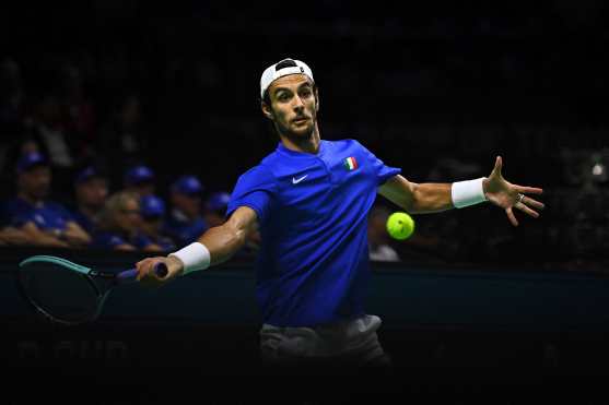 Lorenzo Musetti of Team Italy returns the ball to Francisco Cerundolo of Team Argentina during their quarter-final singles match between Italy and Argentina at the Davis Cup Finals at the Palacio de Deportes Jose Maria Martin Carpena arena in Malaga, southern Spain, on November 21, 2024. (Photo by JORGE GUERRERO / AFP)