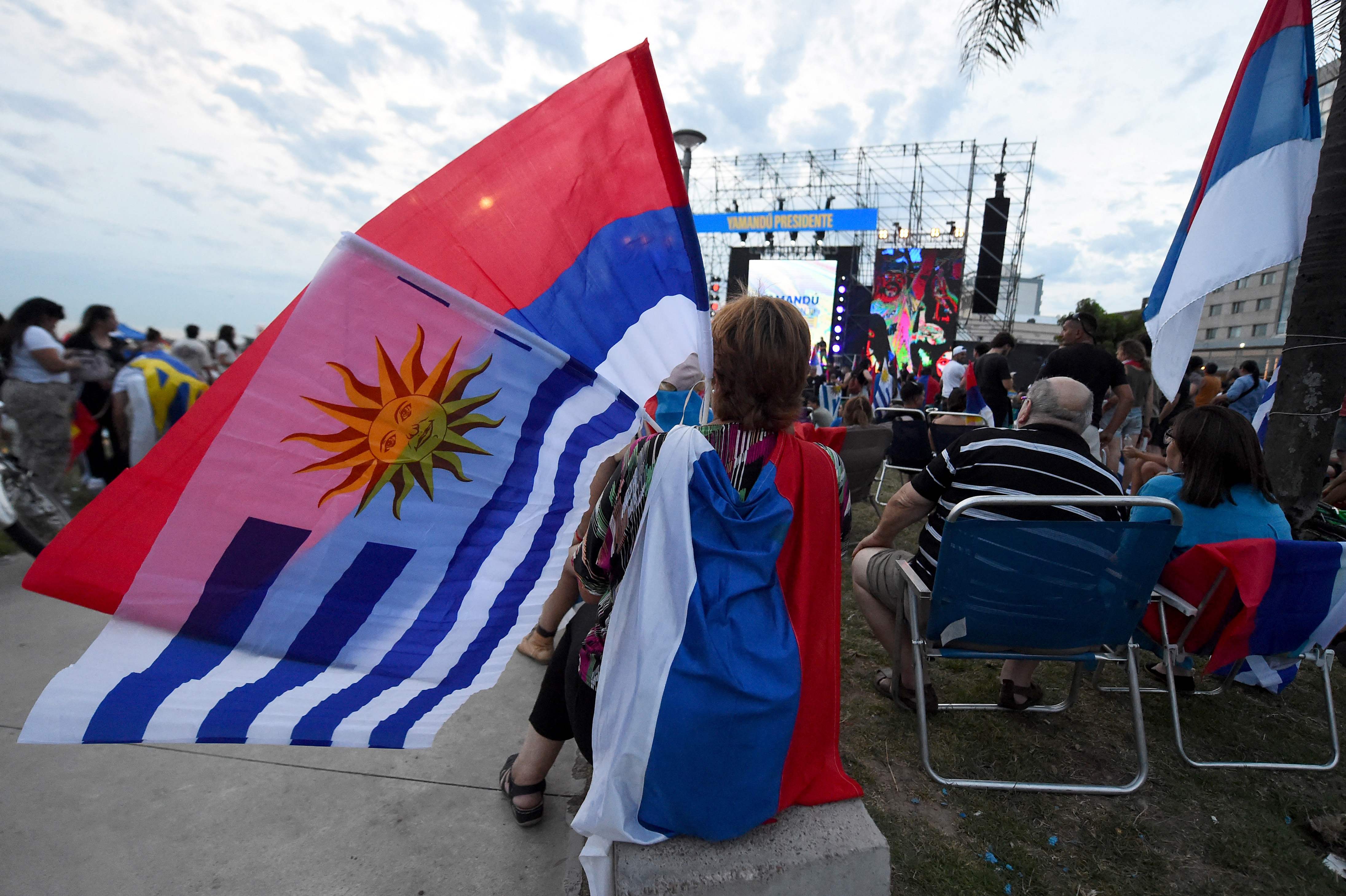 Supporters of Uruguay's presidential candidate for the Frente Amplio party, Yamandu Orsi, wait for the results of the presidential runoff election at la Rambla in Montevideo on November 24, 2024. Uruguayans voted Sunday in what looks to be a tight election, with the leftist alliance of celebrated ex-president Jose "Pepe" Mujica hoping to reclaim the country's top job after five years of right-wing rule. (Photo by Dante FERNANDEZ / AFP)