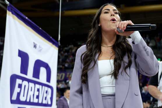 SEATTLE, WASHINGTON - JANUARY 18: Former Washington Huskies womens basketball player Kelsey Plum pretends to bark like a husky dog during her #10 jersey retirement ceremony during halftime between the Washington Huskies Purdue Boilermakers at Alaska Airlines Arena on January 18, 2025 in Seattle, Washington. At Washington (2013-17), Plum became the all-time NCAA scoring leader (3,527 points  stood until 2024) and broke the 33-year-old NCAA career free throw record (912).   Steph Chambers/Getty Images/AFP (Photo by Steph Chambers / GETTY IMAGES NORTH AMERICA / Getty Images via AFP)