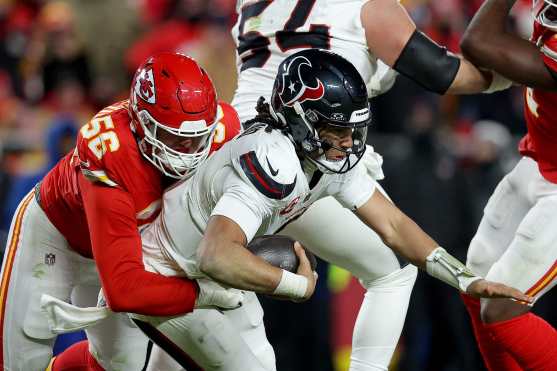 KANSAS CITY, MISSOURI - JANUARY 18: George Karlaftis #56 of the Kansas City Chiefs sacks C.J. Stroud #7 of the Houston Texans during the fourth quarter in the AFC Divisional Playoff at GEHA Field at Arrowhead Stadium on January 18, 2025 in Kansas City, Missouri.   David Eulitt/Getty Images/AFP (Photo by David Eulitt / GETTY IMAGES NORTH AMERICA / Getty Images via AFP)