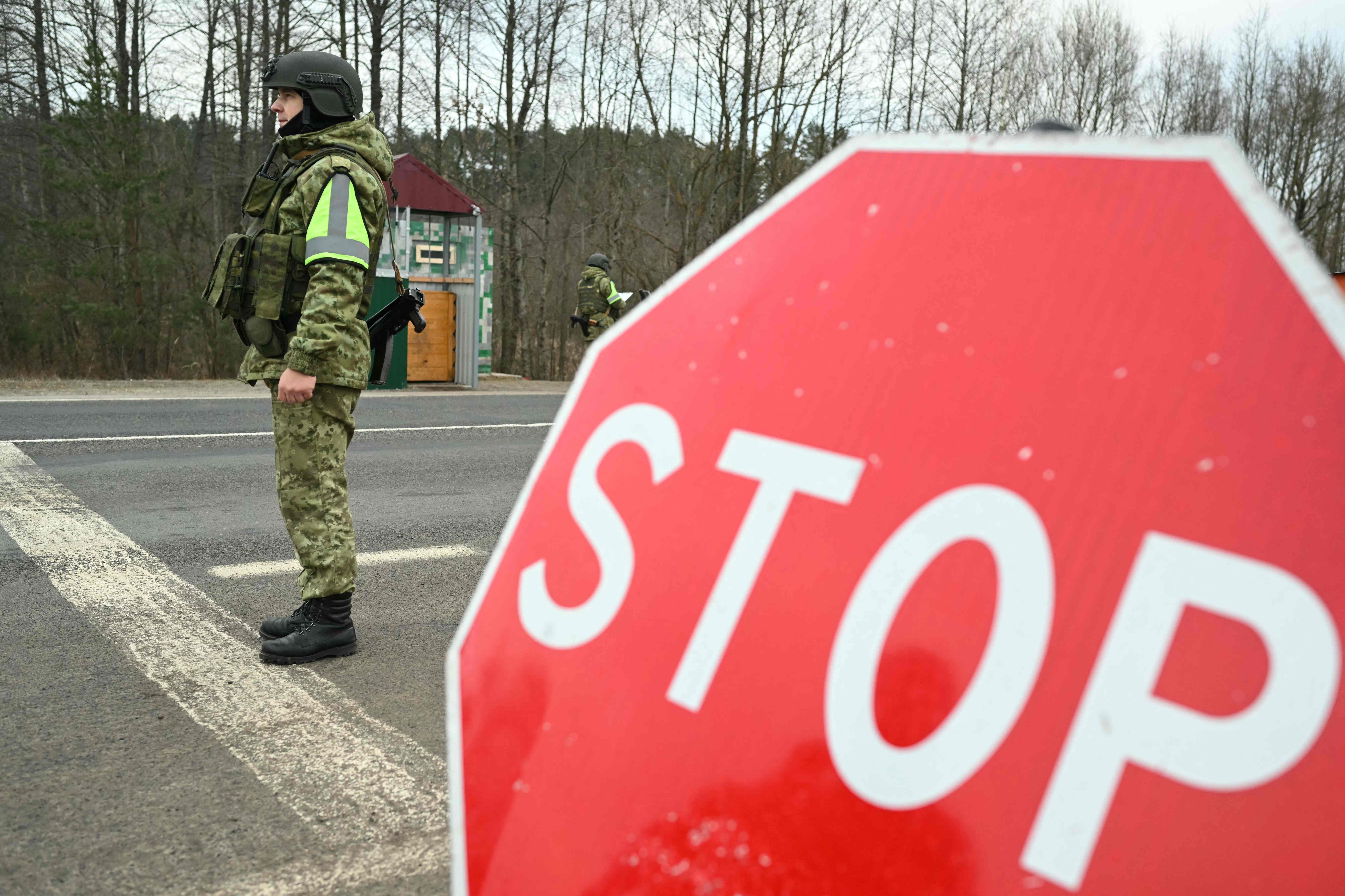 Belarusian border guards keep watch at Teryukha checkpoint on the Belarusian-Ukrainian border in the Gomel region on January 28, 2025. (Photo by Natalia KOLESNIKOVA / AFP)