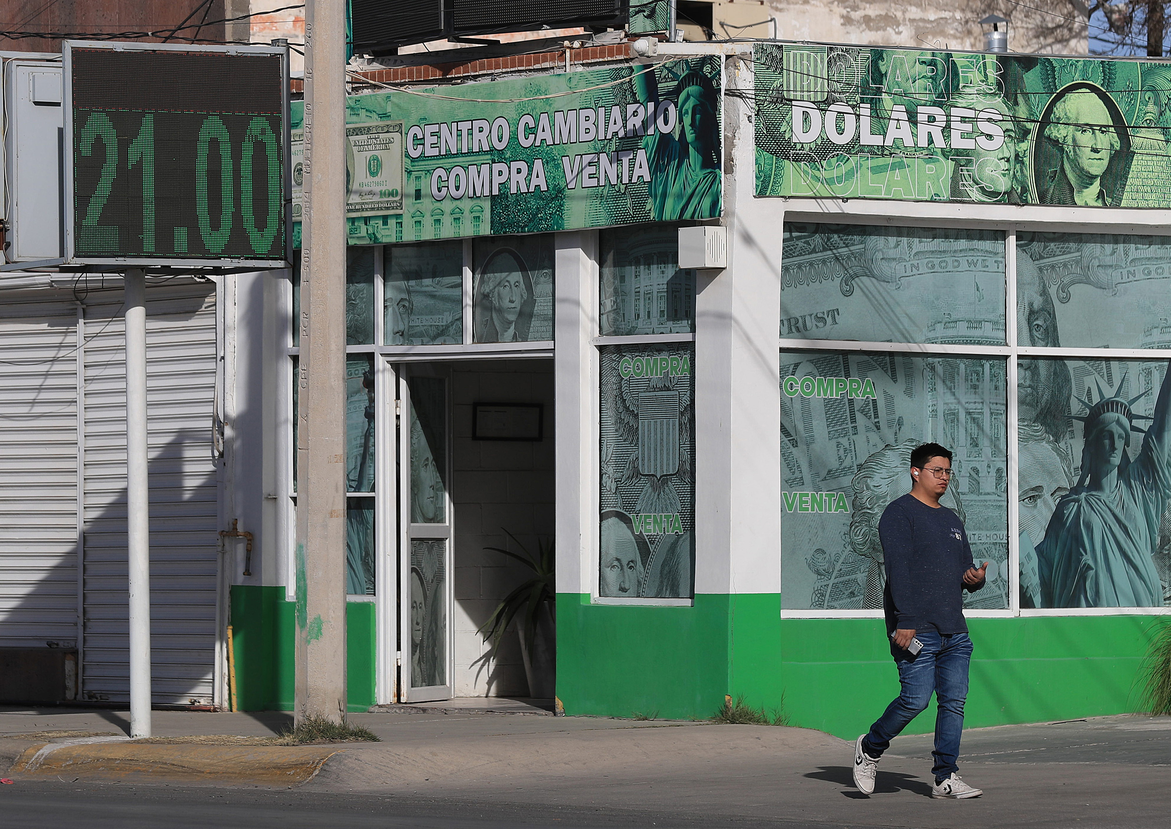 MEX1833. CIUDAD JUÁREZ (MÉXICO), 04/02/2025.- Una persona camina frente a una casa de cambio este lunes, en Ciudad Juárez, en Chihuahua (México). Las remesas en México subieron un 2,3 % en 2024 a un récord de 64.745 millones de dólares a pesar de una caída interanual de casi el 5 % en diciembre, según reportó el Banco de México (Banxico) este martes, en medio de las preocupaciones por las políticas del presidente de Estados Unidos, Donald Trump. EFE/ Luis Torres