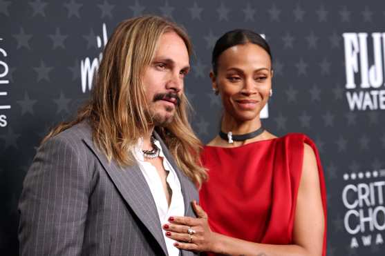 US actress Zoe Saldana (R) and her husband Marco Perego-Saldana attend the 30th Annual Critics Choice Awards at Barker Hangar in Santa Monica, California, on February 7, 2025. (Photo by Michael Tran / AFP)