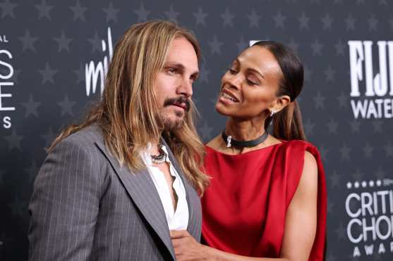 US actress Zoe Saldana (R) and her husband Marco Perego-Saldana attend the 30th Annual Critics Choice Awards at Barker Hangar in Santa Monica, California, on February 7, 2025. (Photo by Michael Tran / AFP)