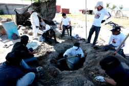 Members of the collective 'Guerreros Buscadores' work on three human crematoriums found while searching for their relatives at Izaguirre Ranch in the community La Estanzuela in Teuchitlan, Jalisco state, Mexico on March 5, 2025. According to local authorities the Izaguirre Ranch was used by organized crime to train new members. (Photo by ULISES RUIZ / AFP)