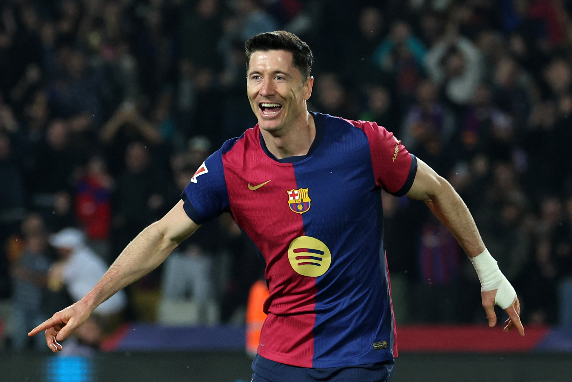 Barcelona's Polish forward #09 Robert Lewandowski celebrates after scoring his team's third goal during the Spanish league football match between FC Barcelona and CA Osasuna at Estadi Olimpic Lluis Companys in Barcelona on March 27, 2025. (Photo by LLUIS GENE / AFP)