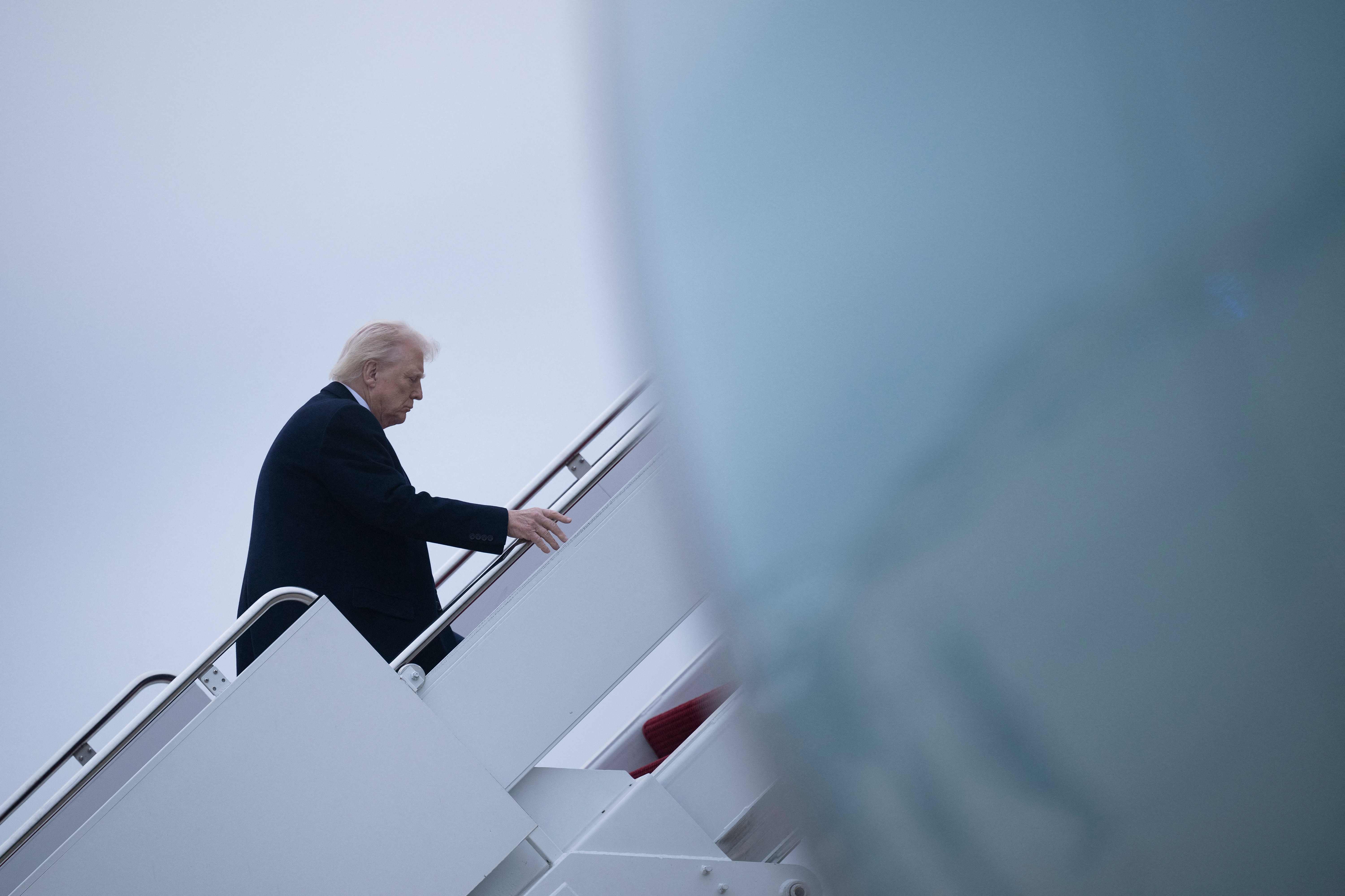 US President Donald Trump boards Air Force One at Joint Base Andrews in Maryland on March 14, 2025. Trump is spending the weekend at his Florida Mar-a-Lago resort. (Photo by Brendan Smialowski / AFP)