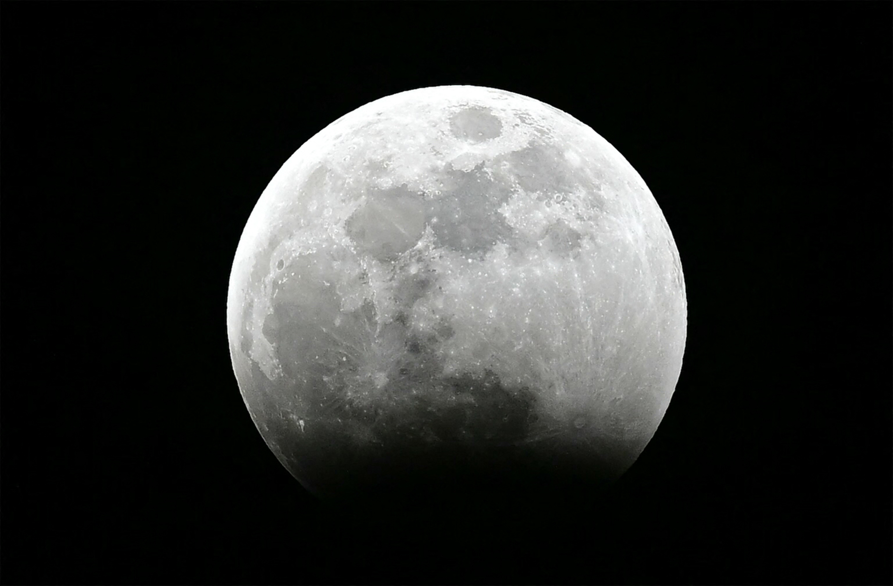 The moon is seen as the umbral eclipse begins during the Blood Moon Lunar Eclipse above Los Angeles, California, on March 13, 2025. (Photo by Frederic J. Brown / AFP)