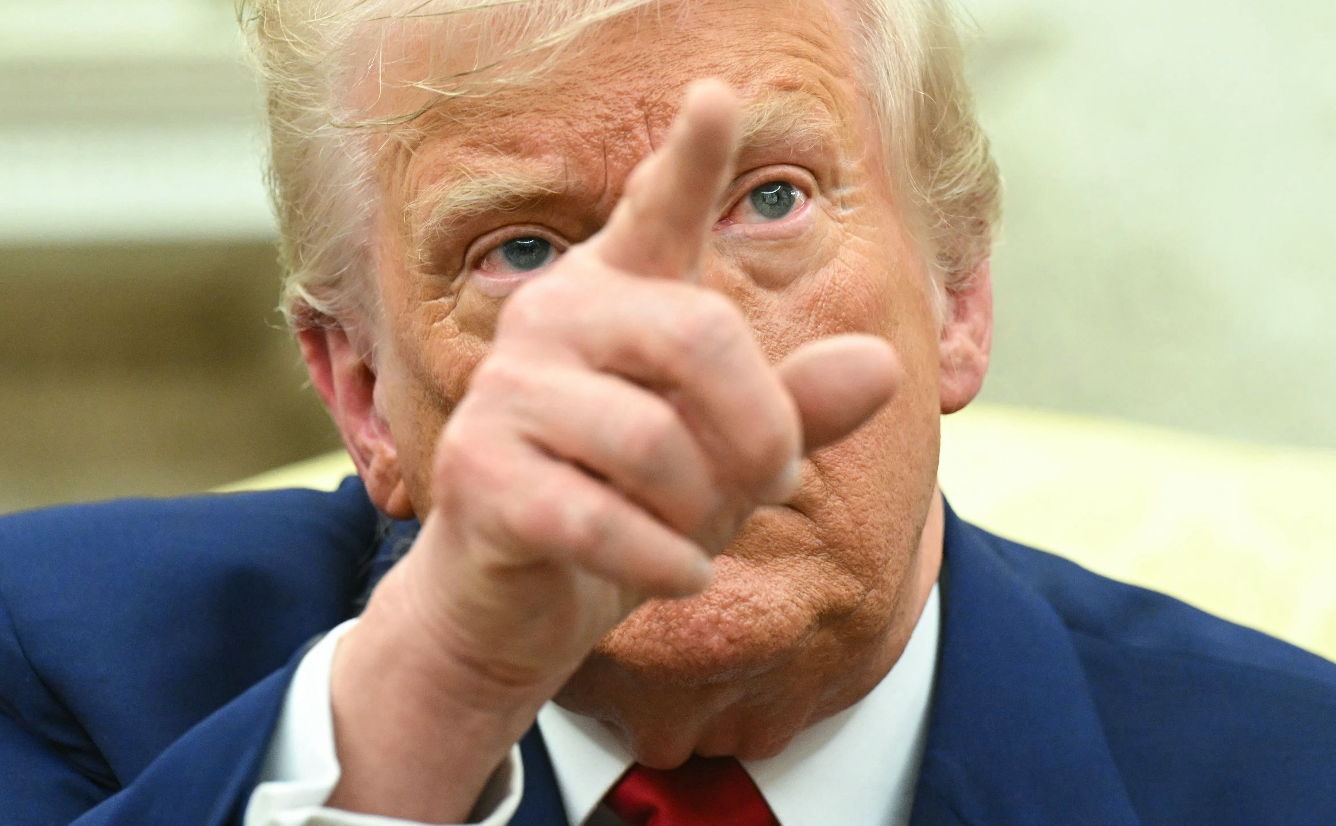 US President Donald Trump gestures during a meeting with Israeli Prime Minister Benjamin Netanyahu in the Oval Office of the White House in Washington, DC, on April 7, 2025. Israeli Prime Minister Benjamin Netanyahu was in Washington on Monday to meet Donald Trump, whom he will likely ask for a reprieve from US tariffs while seeking further backing on Iran and Gaza. (Photo by SAUL LOEB / AFP)