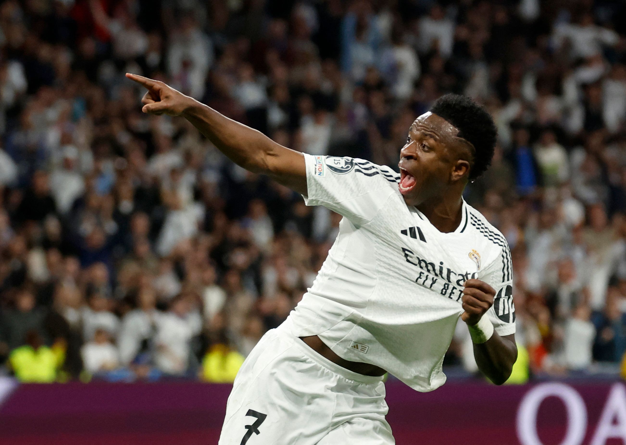 Real Madrid's Brazilian forward #07 Vinicius Junior celebrates scoring his team's first goal during the UEFA Champions League quarter final second leg football match between Real Madrid CF and Arsenal at Santiago Bernabeu Stadium in Madrid on April 16, 2025. (Photo by Pierre-Philippe MARCOU / AFP)