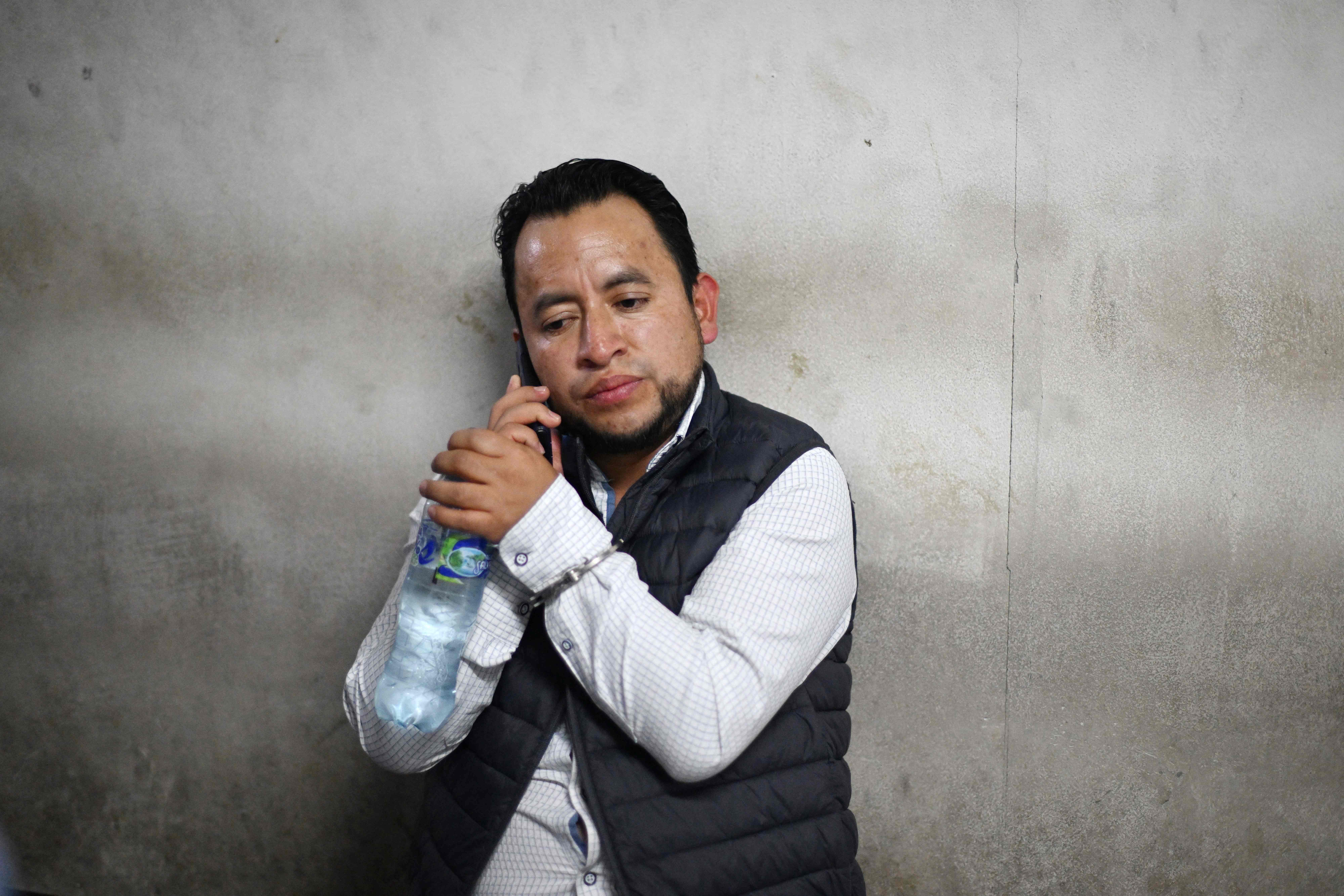 Guatemalan Vice-Minister of Energy and Mines Luis Pacheco talks on a mobile phone as he arrives at the court after being arrested on charges of terrorism and other crimes in Guatemala City on April 23, 2025. The Guatemalan police, at the request of the Attorney General's Office, arrested on April 23, 2025, for terrorism Vice Minister Luis Pacheco, who in 2023 led protests against Attorney General Consuelo Porras, accused of promoting a coup d'état to prevent the inauguration of President Bernardo Arévalo. (Photo by JOHAN ORDONEZ / AFP)