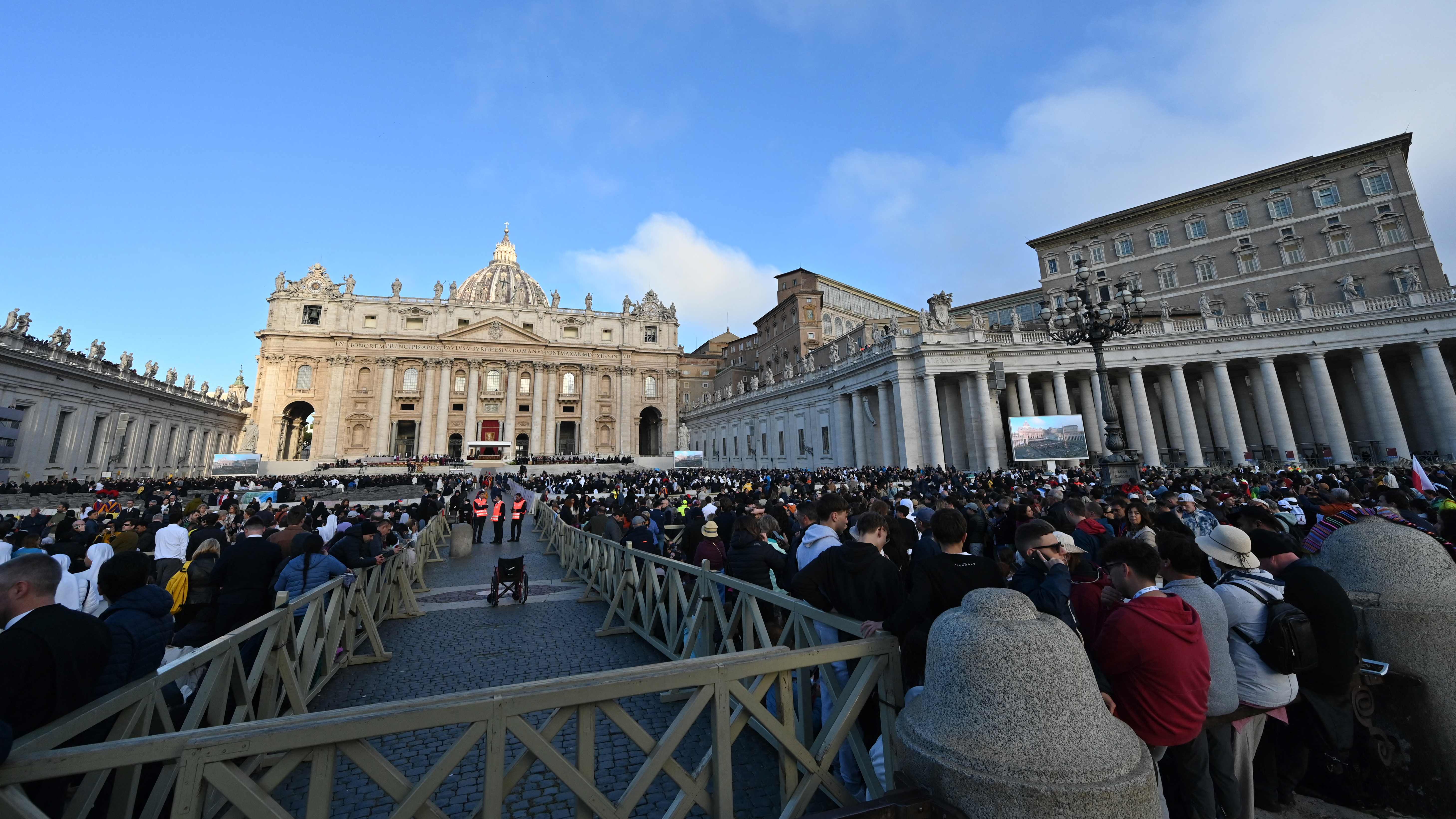 Attendees arrive at St Peter's Square with St Peter's Basilica in the background ahead of late Pope Francis' funeral in the Vatican on April 26, 2025. Pope Francis, champion of the poor and the Church's first Latin American leader, will be honoured April 26 with a funeral attended by world leaders and tens of thousands of Catholic faithful. The Argentine pontiff, who died on April 21, 2025, aged 88, sought to create a more open-minded Church during his 12-year papacy, and many emotional tributes have been made -- with 250,000 people paying respects at his coffin in St Peter's Basilica. (Photo by Andreas SOLARO / AFP)