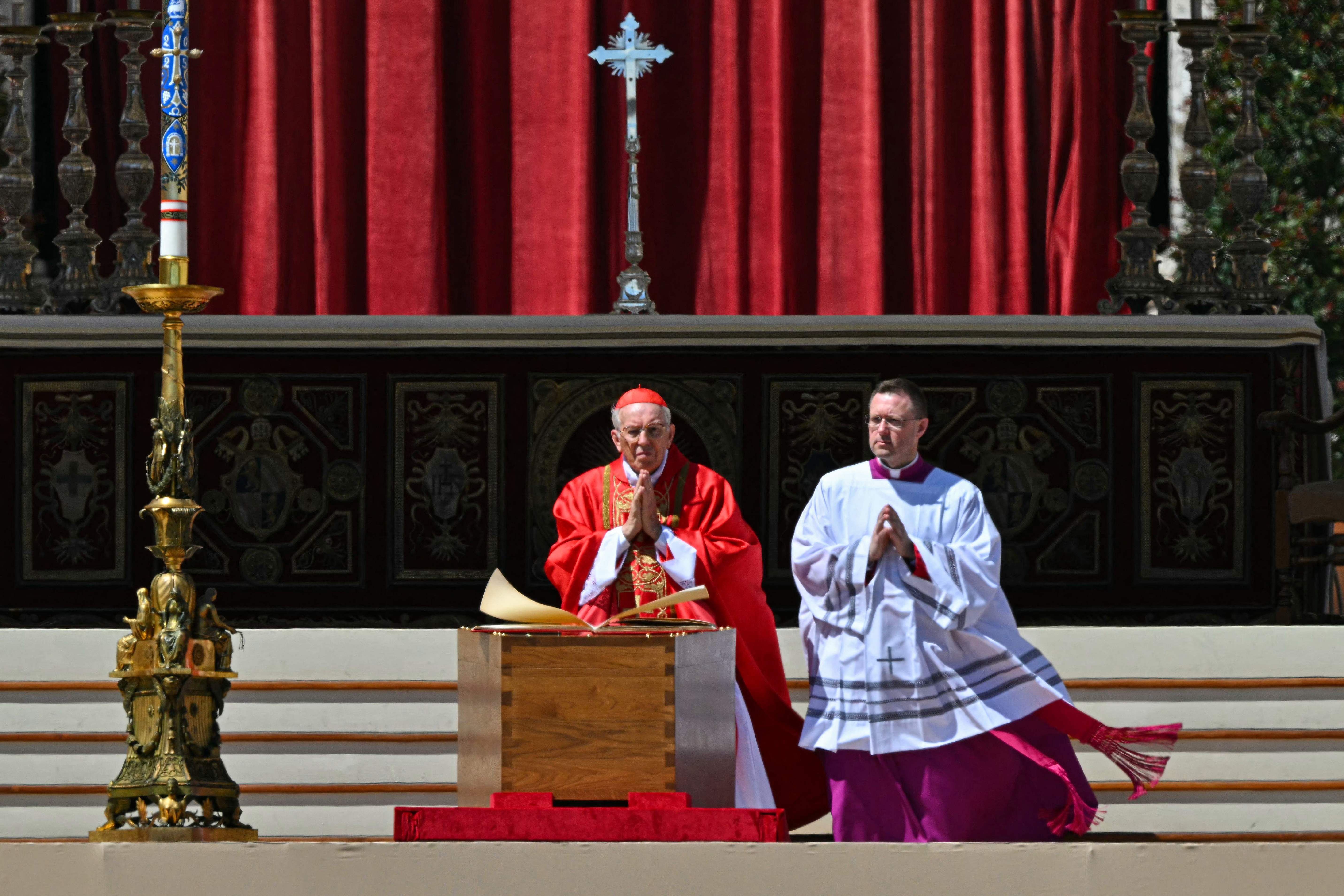 El cardenal italiano Giovanni Battista Re (izquierda) oficia cerca del ataúd del papa Francisco durante la ceremonia en El Vaticano. (Foto Prensa Libre: AFP)