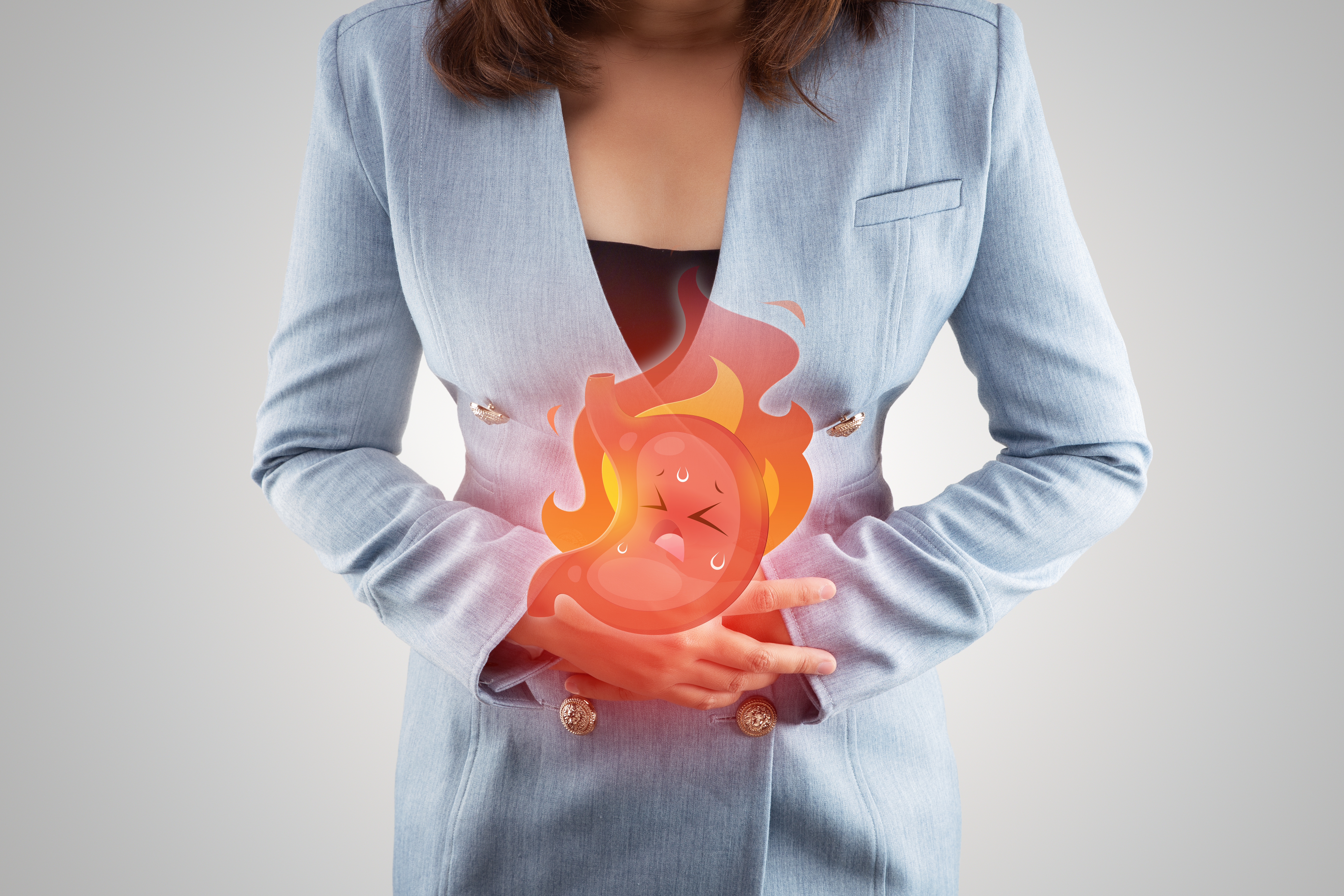 Acid reflux disease symptoms or heartburn, illustration stomach burn on woman's body against gray backgroundd, Concept with healthcare and medicine