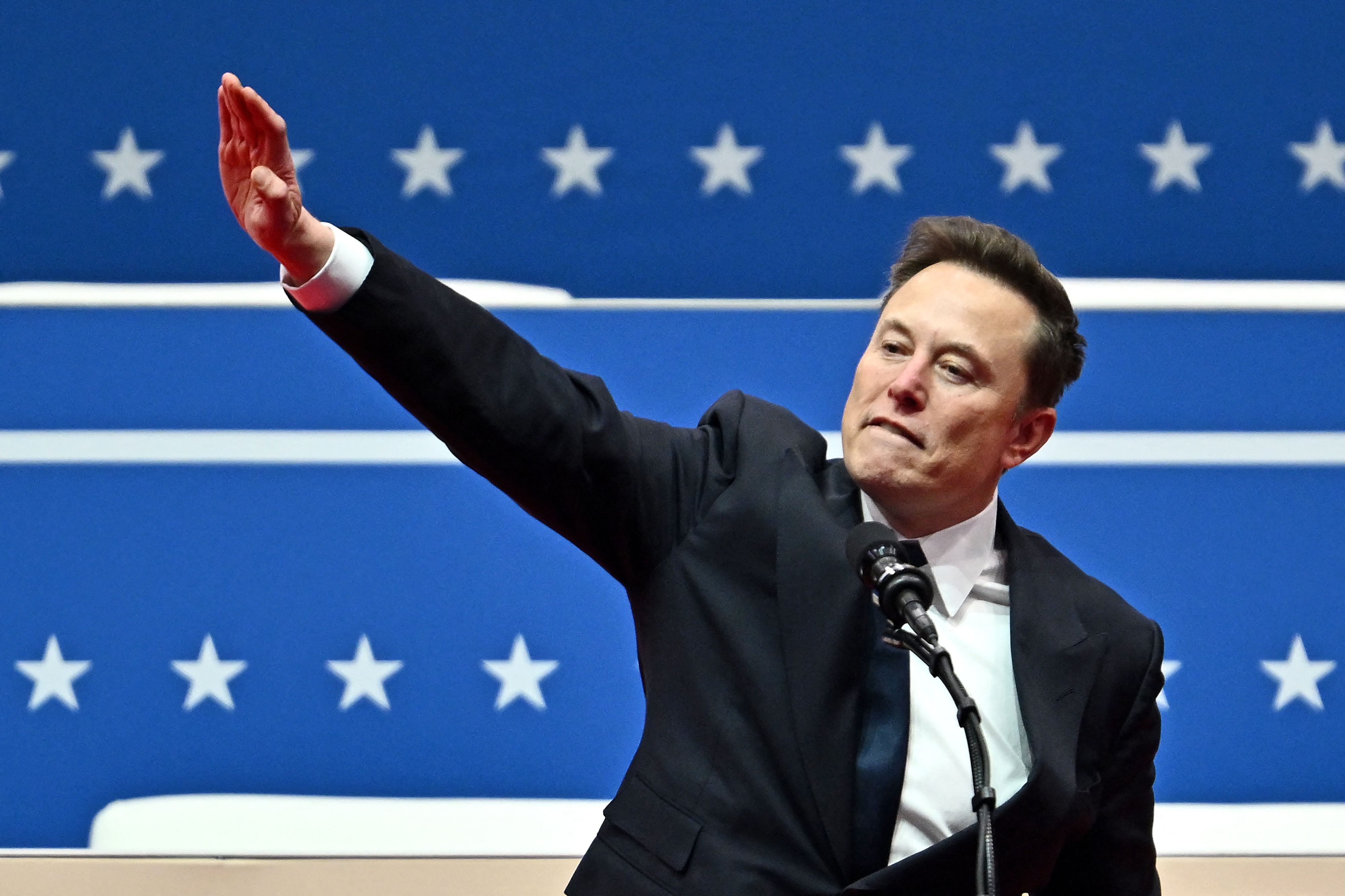 (FILES) Tesla and SpaceX CEO Elon Musk gestures as he speaks during the inaugural parade inside Capital One Arena, in Washington, DC, on January 20, 2025. Musk's rise as President Donald Trump's all-powerful wingman was as rapid and unstoppable as one of his SpaceX rockets. But reports April 2, 2025 are fueling speculation that the billionaire's political career may be coming back to Earth. Politico and ABC News quoted unnamed sources saying Musk could step away from an unprecedented role in which he is spearheading brutal cuts to US government services and has emerged only second to Trump as the face of the administration. (Photo by ANGELA WEISS / AFP)