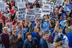 Demonstrators hold signs and cheer on speakers at a May Day rally in Boston Common in Boston, Massachusetts on May 1, 2025. Rally goers protested US President Trump and his policies and called for union rights. (Photo by Joseph Prezioso / AFP)