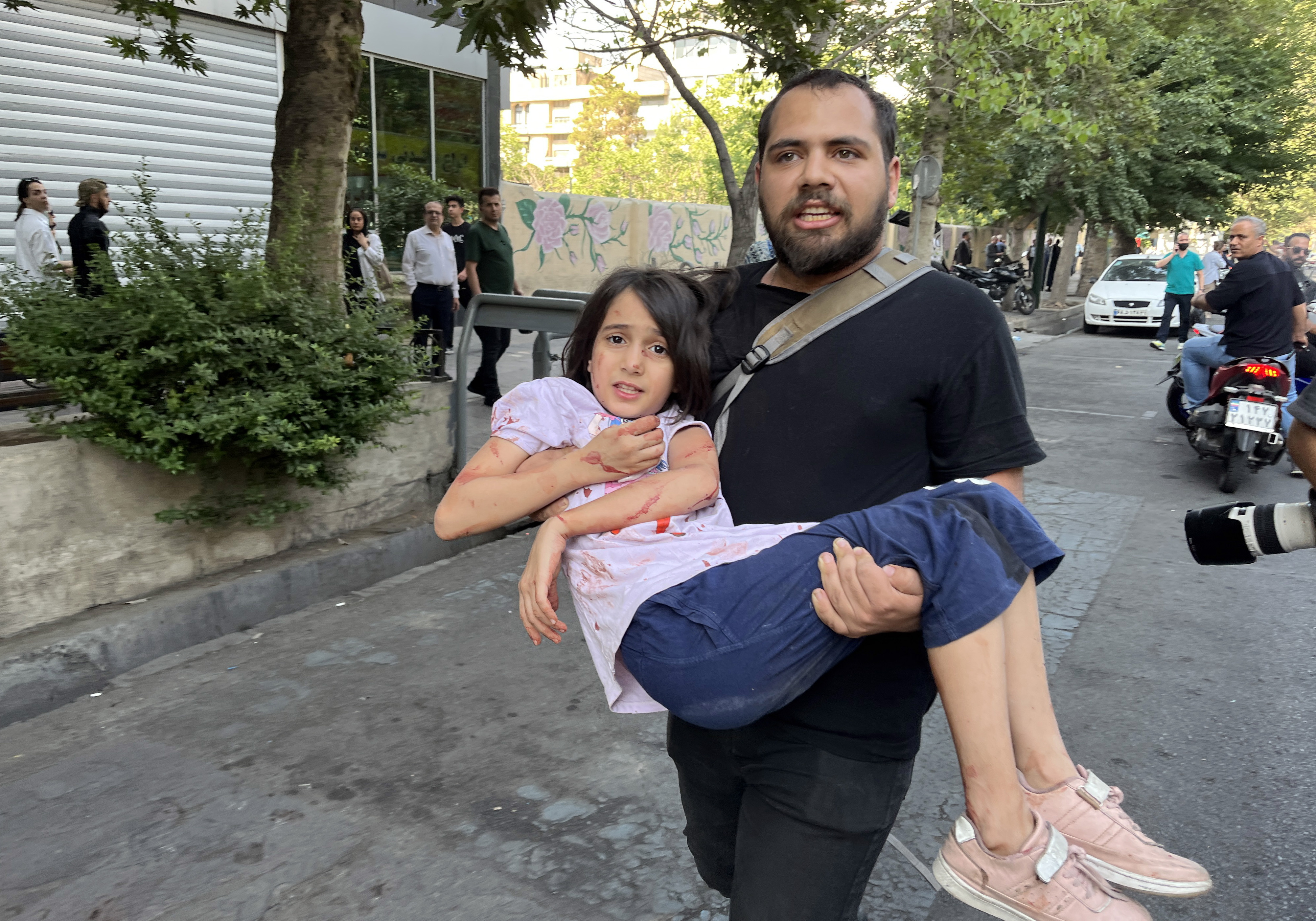 Un hombre carga a su hija herido tras un ataque aéreo israelí en el centro de Teherán, Irán. (Foto Prensa Libre: EFE)