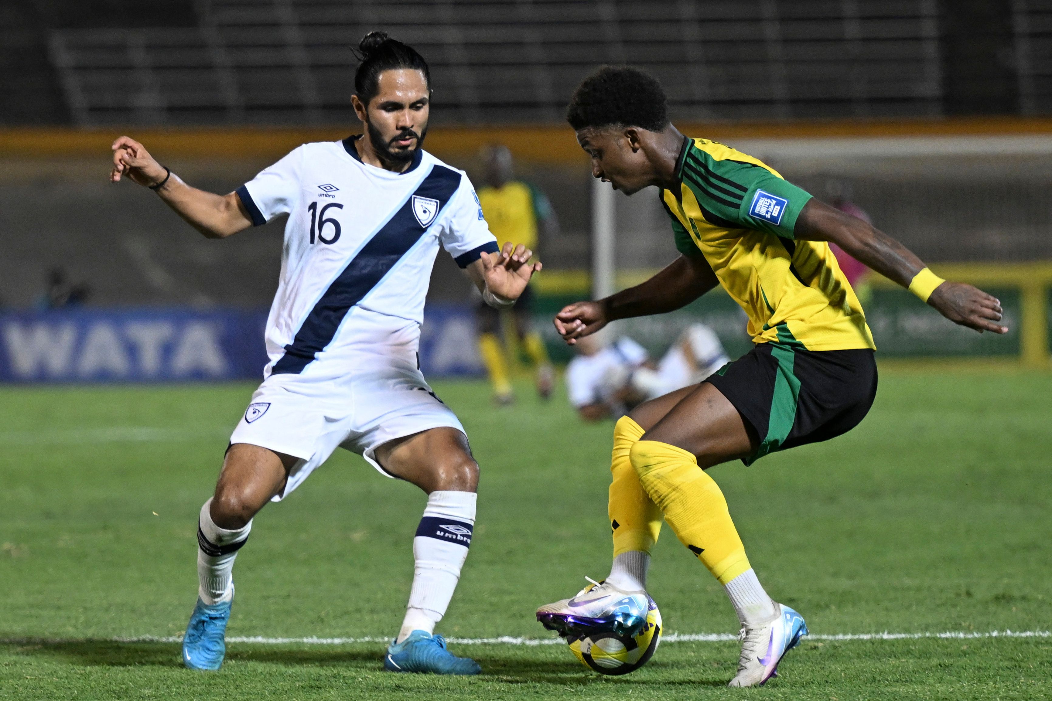 Guatemala's defender #16 Jose Morales and Jamaica's forward #11 Demarai Gray fight for the ball during the 2026 FIFA World Cup Concacaf qualifier football match between Jamaica and Guatemala at the Independence Park stadium in Kingston on June 10, 2025. (Photo by Ricardo Makyn / AFP)