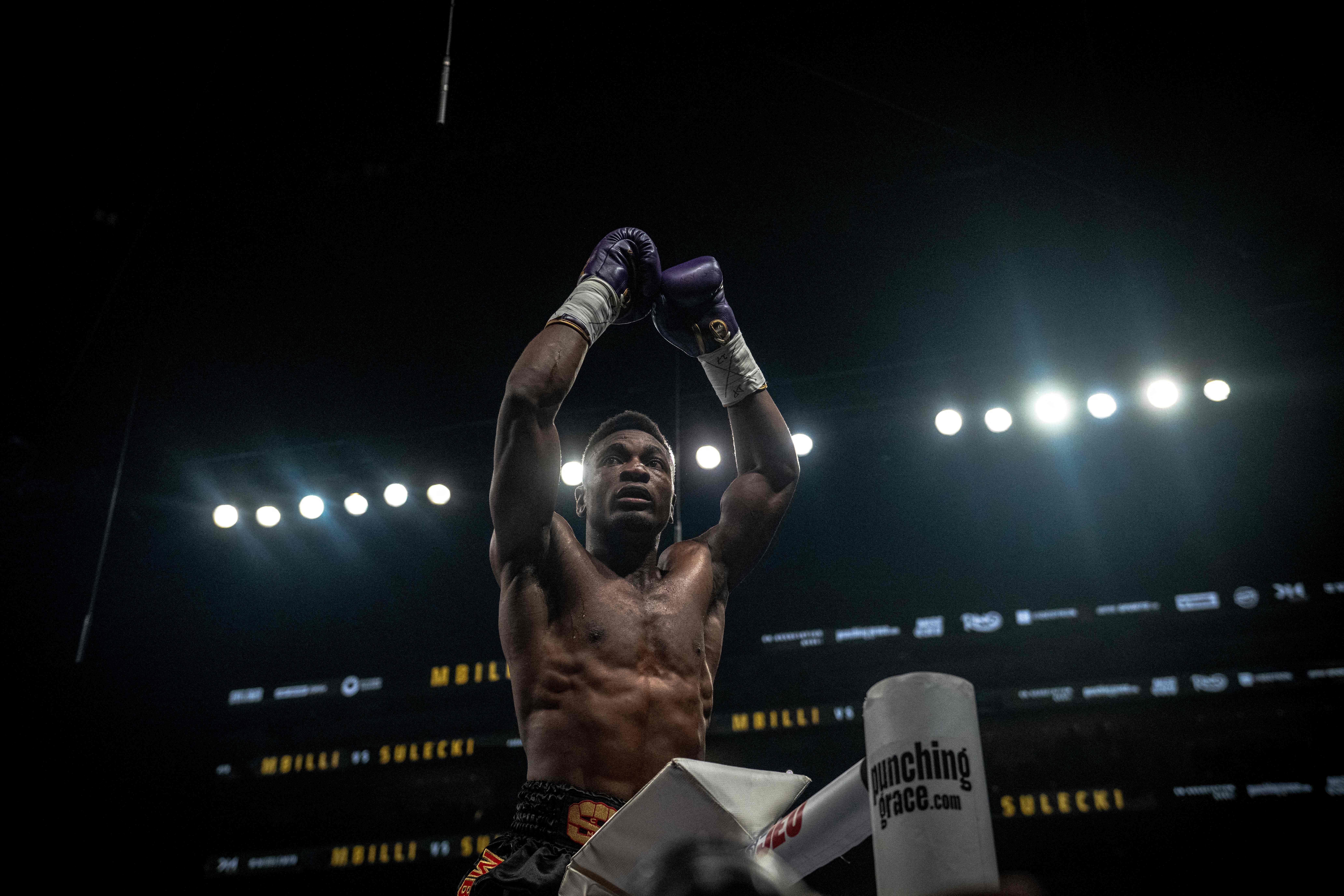 France's Christian Mbilli celebrates his victory over unseen Poland's Maciej Sulecki during their WBC Interim Super Middleweight title bout at the Videotron Centre in Quebec City, Quebec, Canada, on June 27, 2025. (Photo by ANDREJ IVANOV / AFP)