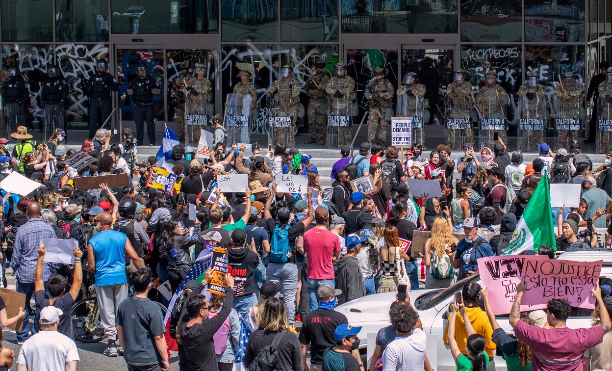 Manifestantes protestan frente miembros de la Guardia Nacional, en un edificio federal en Los Ángeles. (Foto Prensa Libre: AFP)