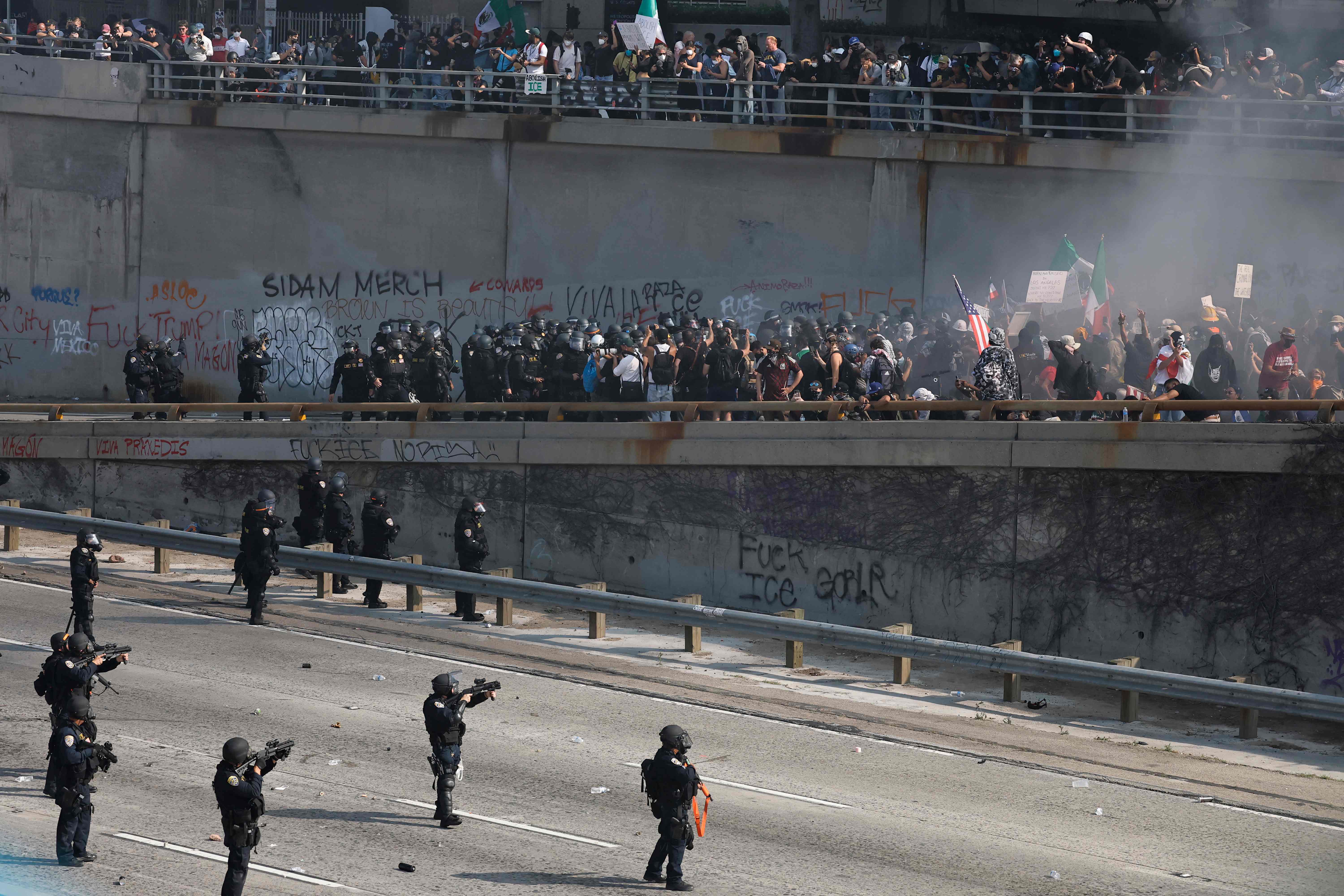 LOS ANGELES, LOS ANGELES - JUNE 08: (EDITORS NOTE: Image contains profanity) California Highway Patrol (CHP) officers clear protestors who were blocking the 101 freeway on June 08, 2025 in Los Angeles, California. Tensions in the city remain high after the Trump administration called in the National Guard against the wishes of city leaders following two days of clashes with police during a series of immigration raids. More protests are scheduled for today.   Mario Tama/Getty Images/AFP (Photo by MARIO TAMA / GETTY IMAGES NORTH AMERICA / Getty Images via AFP)