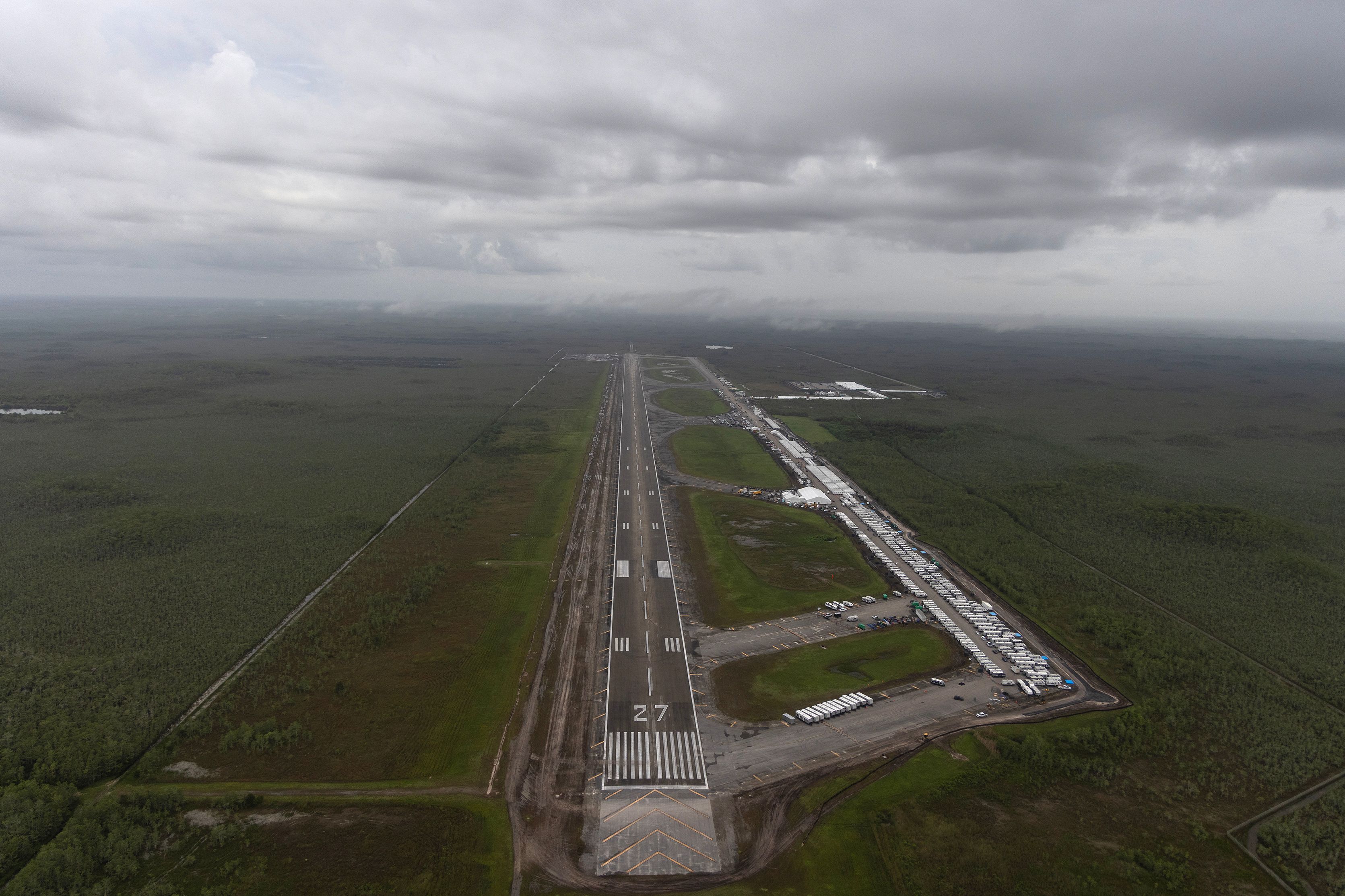 OCHOPEE, FLORIDA - JULY 4: In an aerial view from a helicopter, the migrant detention center, dubbed "Alligator Alcatraz," is seen located at the site of the Dade-Collier Training and Transition Airport on July 4, 2025 in Ochopee, Florida. U.S. President Donald Trump was present at the opening of the 5,000-bed facility, located at an abandoned airfield in the Everglades wetlands, as part of his expansion of undocumented migrant deportations.   Alon Skuy/Getty Images/AFP (Photo by Alon Skuy / GETTY IMAGES NORTH AMERICA / Getty Images via AFP)