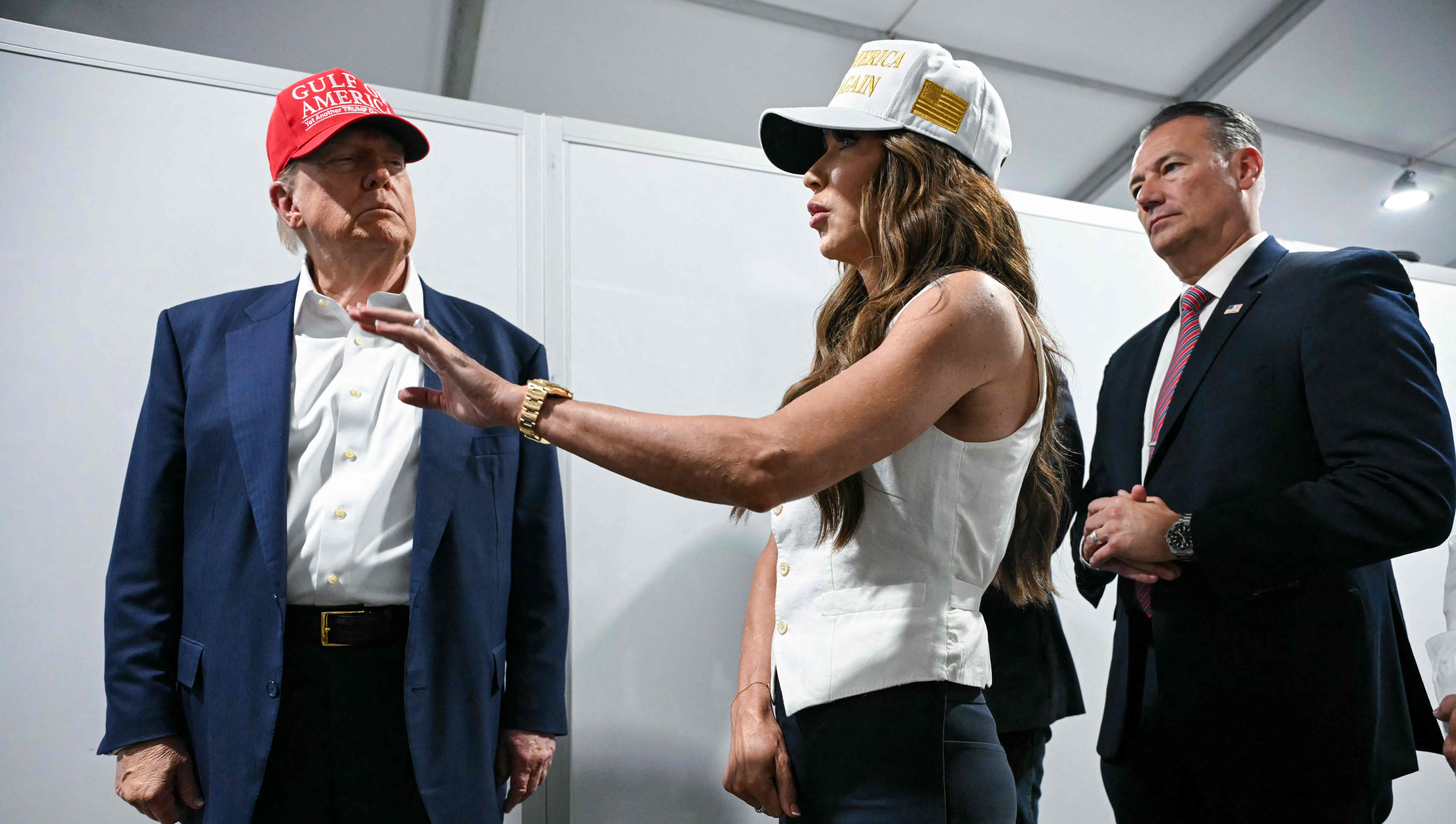 US President President Donald Trump speaks with Secretary of Homeland Security Kristi Noem as they tour a migrant detention center, dubbed "Alligator Alcatraz," located at the site of the Dade-Collier Training and Transition Airport in Ochopee, Florida on July 1, 2025. President Trump is visiting a migrant detention center in a reptile-infested Florida swamp dubbed "Alligator Alcatraz." Trump will attend the opening of the 5,000-bed facility -- located at an abandoned airfield in the Everglades wetlands -- part of his expansion of deportations of undocumented migrants, his spokeswoman said. (Photo by ANDREW CABALLERO-REYNOLDS / AFP)