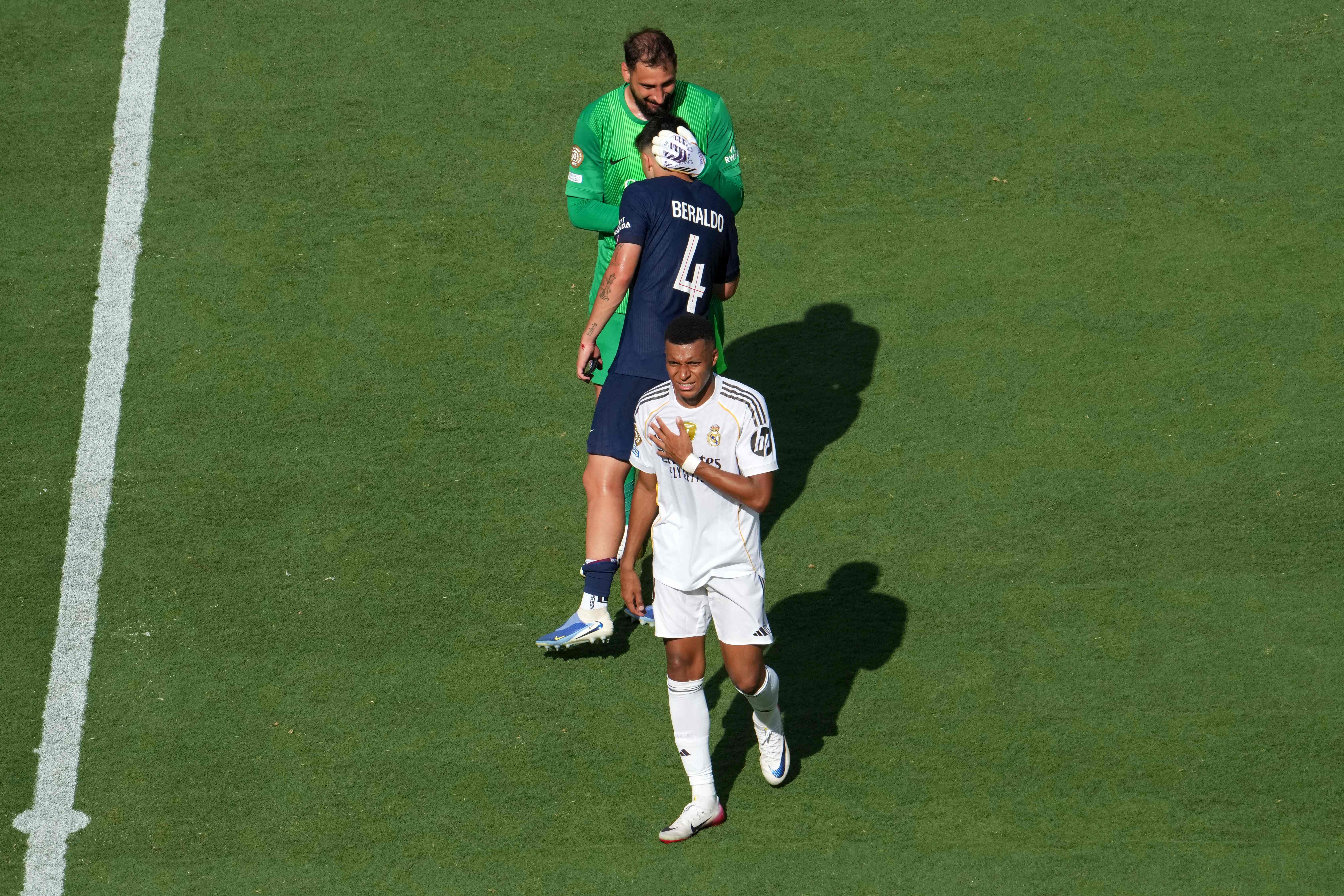 Paris Saint-Germain's Italian goalkeeper #01 Gianluigi Donnarumma greets Paris Saint-Germain's Brazilian defender #04 Lucas Beraldo as Real Madrid's French forward #09 Kylian Mbappe reacts at the end of the FIFA Club World Cup 2025 semifinal football match between France's Paris Saint-Germain and Spain's Real Madrid at MetLife stadium in East Rutherford, New Jersey on July 9, 2025. (Photo by TIMOTHY A. CLARY / AFP)