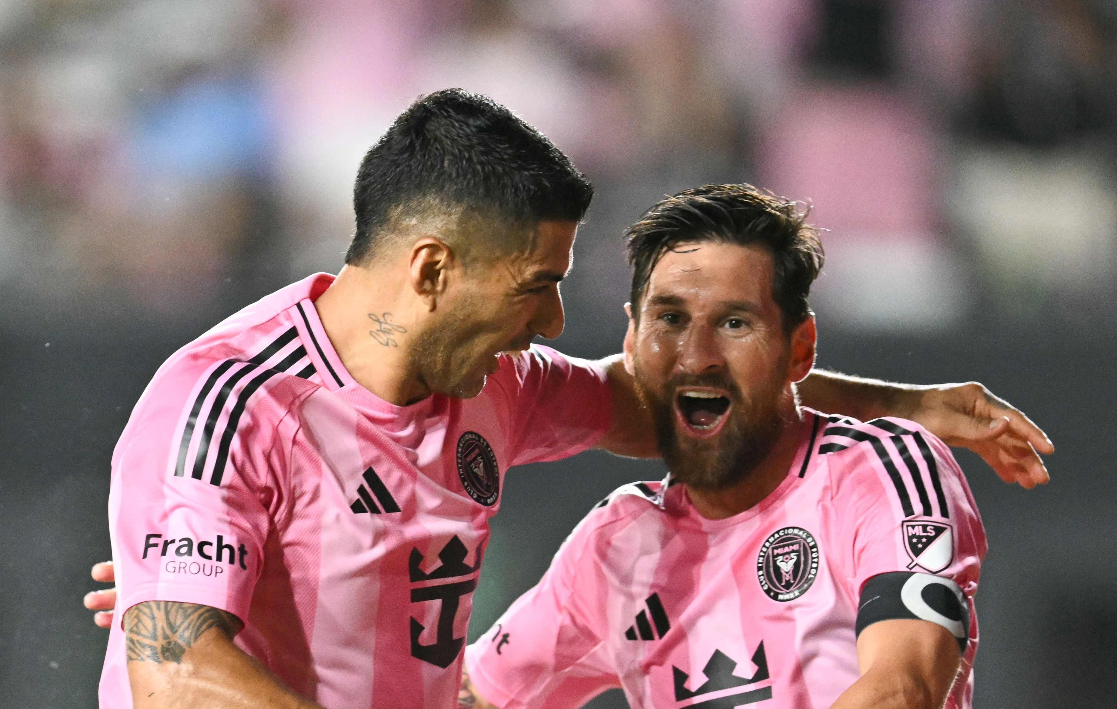 Inter Miami's Argentine forward #10 Lionel Messi celebrates with Inter Miami's Uruguayan forward #09 Luis Suarez after scoring his team's second goal during the Major League Soccer (MLS) regular season soccer match between Inter Miami CF and Nashville SC at Chase Stadium in Fort Lauderdale, Florida on July 12, 2025. (Photo by CHANDAN KHANNA / AFP)