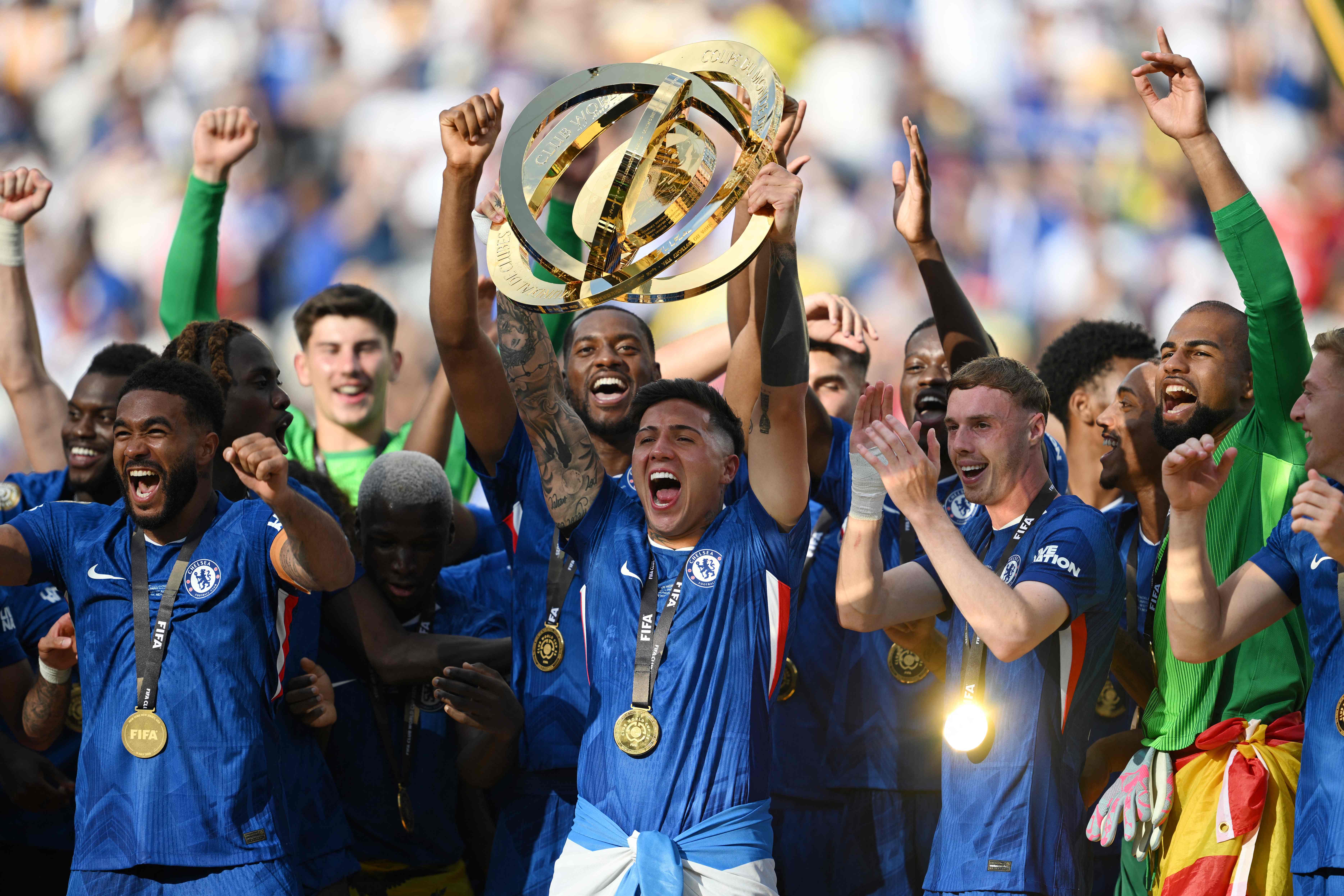 Chelsea's Argentinian midfielder #08 Enzo Fernandez lifts the trophy with teammates during the award ceremony for the FIFA Club World Cup 2025 Champions, following the final football match between England's Chelsea and France's Paris Saint-Germain at the MetLife Stadium in East Rutherford, New Jersey on July 13, 2025. (Photo by ANGELA WEISS / AFP)