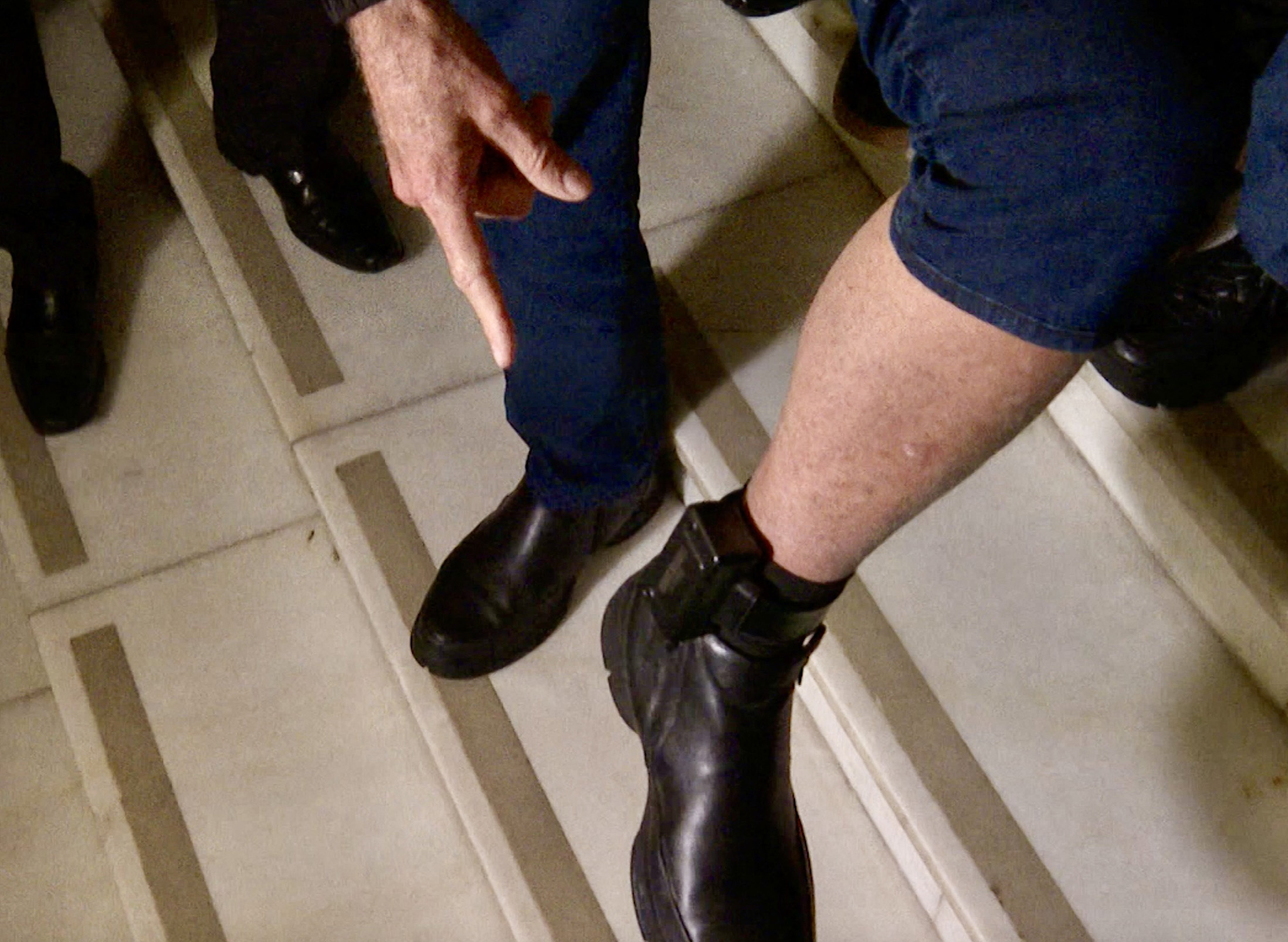 This frame grab from AFPTV video footage shows former Brazilian President Jair Bolsonaro with his ankle monitor as he leaves the National Congress in Brasilia on July 21, 2025. Bolsonaro, who was ordered by the Supreme Court to wear an ankle monitor, received support from Liberal Party lawmakers during a meeting held on July 21, 2025. (Photo by JOSÉ OSORIO / AFP)