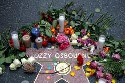 Flowers are left at a makeshift memorial at Ozzy Osbourne's Star on the Hollywood Walk of Fame on July 22, 2025, in Los Angeles. Osbourne, the legendary frontman of heavy metal group Black Sabbath, died on Tuesday at the age of 76, his family announced in a statement. "He was with his family and surrounded by love. We ask everyone to respect our family privacy at this time," the statement said. (Photo by Patrick T. Fallon / AFP)
