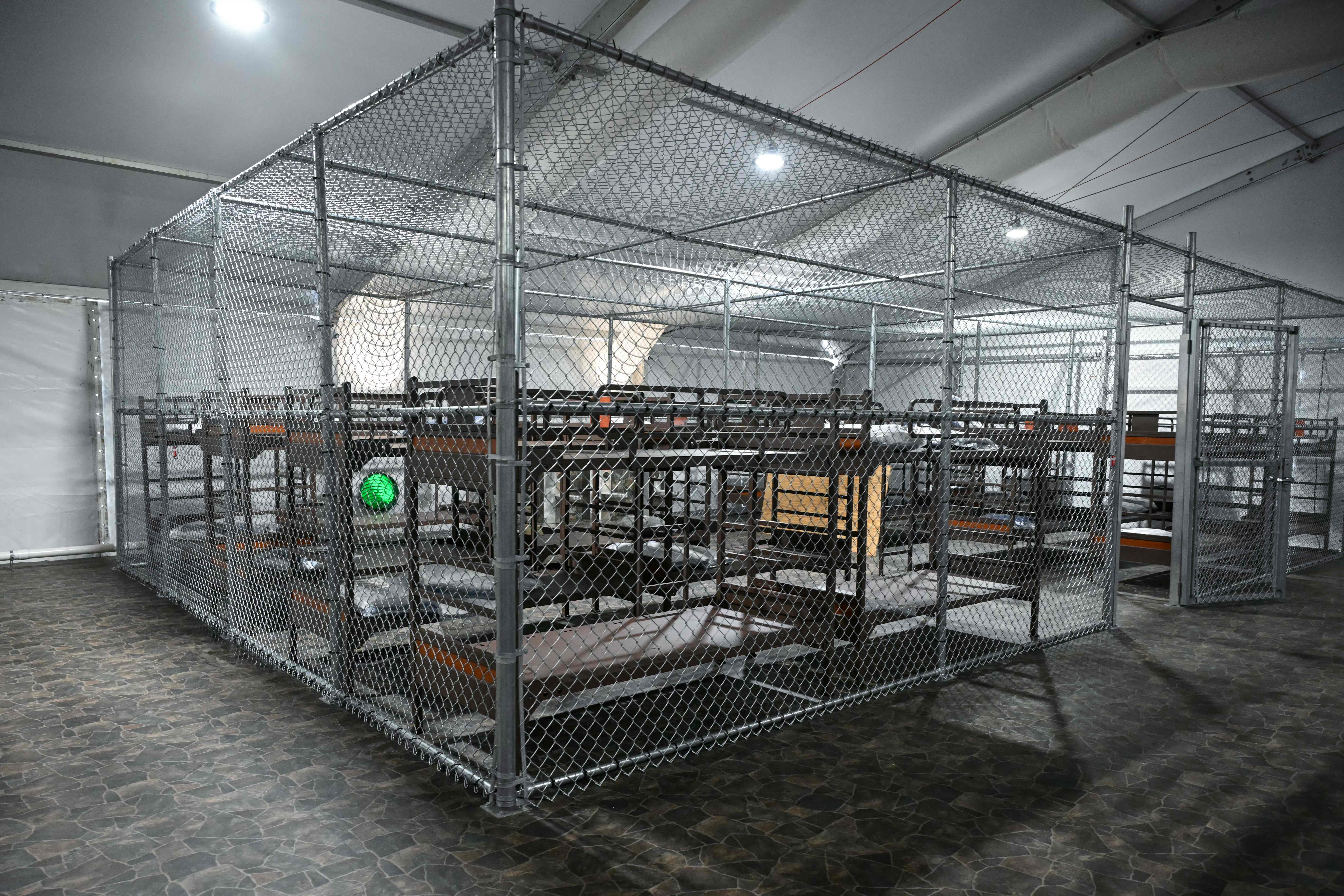 Beds are seen inside a migrant detention center, dubbed "Alligator Alcatraz," located at the site of the Dade-Collier Training and Transition Airport, as US President Donald Trump tours the facility in Ochopee, Florida on July 1, 2025. President Trump is visiting a migrant detention center in a reptile-infested Florida swamp dubbed "Alligator Alcatraz." Trump will attend the opening of the 5,000-bed facility -- located at an abandoned airfield in the Everglades wetlands -- part of his expansion of deportations of undocumented migrants, his spokeswoman said. (Photo by ANDREW CABALLERO-REYNOLDS / AFP)