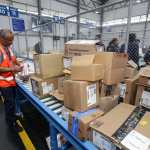 trabajadores revisando paquetes en Combe-Im en bodegas ampliadas por crecimiento de comercio electrónico
