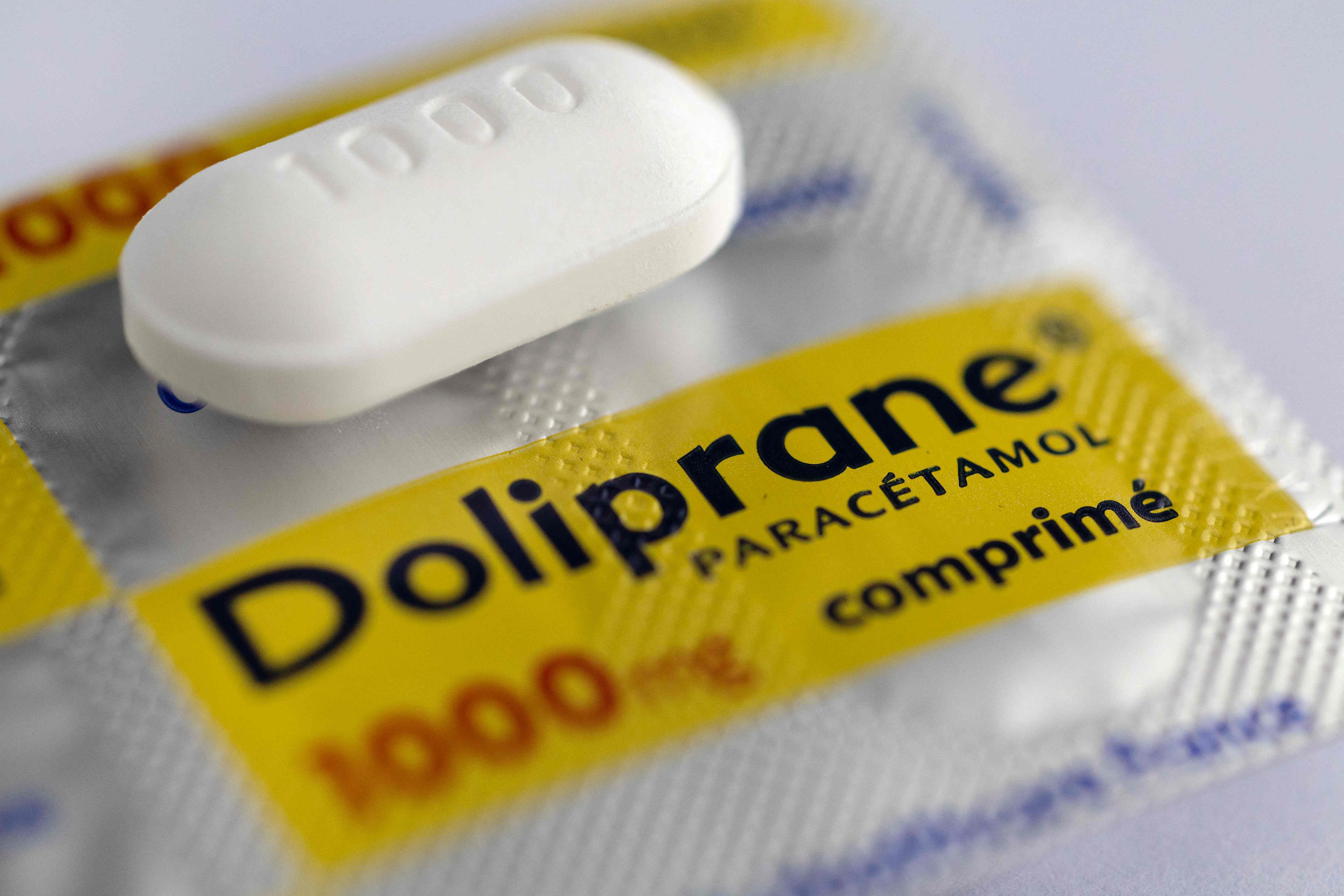 (FILES) This photograph shows a tablet of paracetamol Doliprane pills in Quimper, western France, on October 16, 2024. Doliprane, the most prescribed drug in France, is officially coming under American control, with the completion on April 30, 2025 of Sanofi's sale of control of the company that produces the popular yellow box to the investment fund CD&R. (Photo by Fred TANNEAU / AFP)