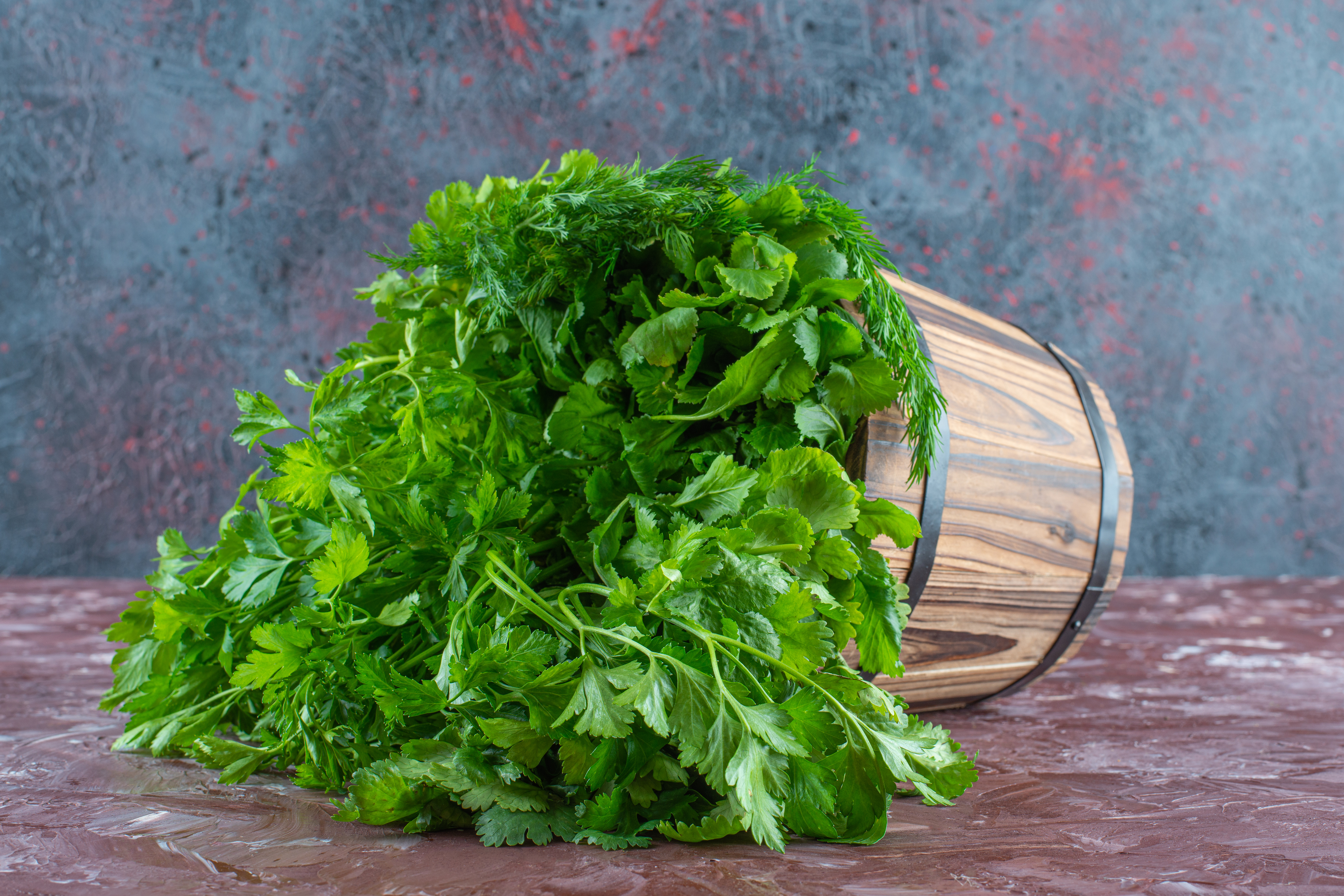 Various greens in a bucket , on the marble background. High quality photo