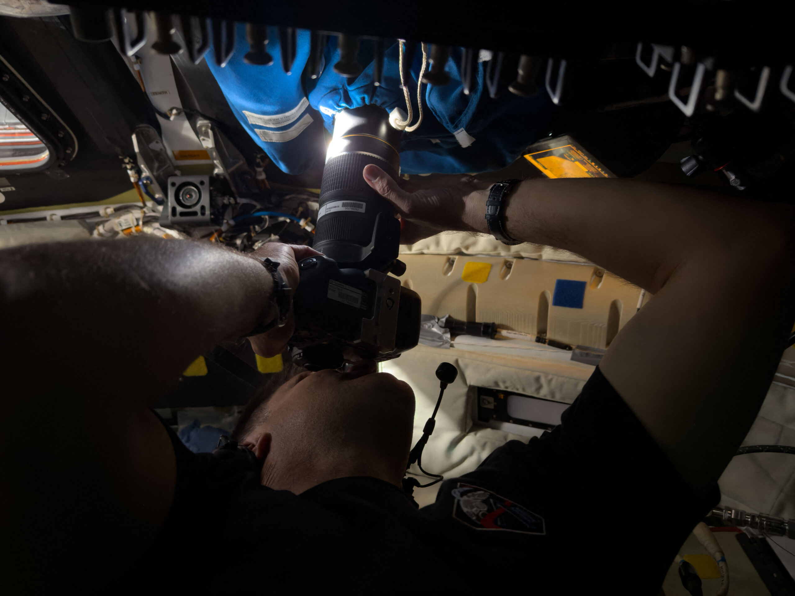 A photo provided by NASA shows Canadian Space Agency astronaut Jeremy Hansen, a member of the Artemis II crew, capturing images through a window of the Orion Integrity spacecraft on Monday evening, April 6, 2026. On the sixth day of the mission, 248,655 miles from Earth, four people Ñ Hansen and NASA astronauts Reid Wiseman, Victor Glover and Christina Koch Ñ ventured farther from home than any human being who has ever lived. (NASA via The New York Times)  Ñ NO SALES; EDITORIAL USE ONLYÑ