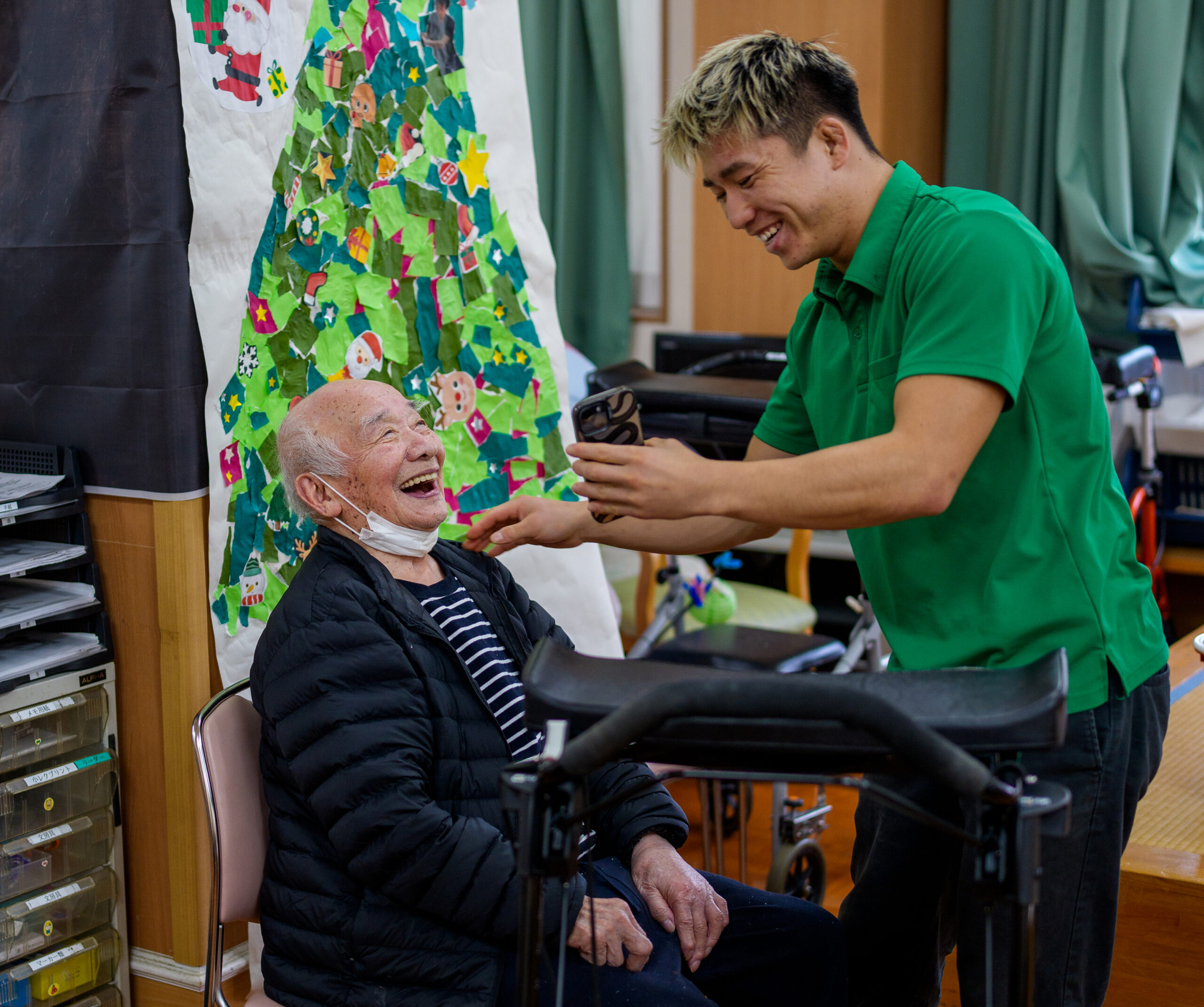 Haru Kihara, right, works with an elder at a nursing home in Kochi Prefecture, Japan, Dec. 8, 2025. With a shortage of workers to care for a growing elderly population, JapanÕs nursing homes are turning to an unconventional solution, recruiting bodybuilders, mixed martial arts fighters and sumo wrestlers to take on roles as caregivers. (Chang W. Lee/The New York Times)