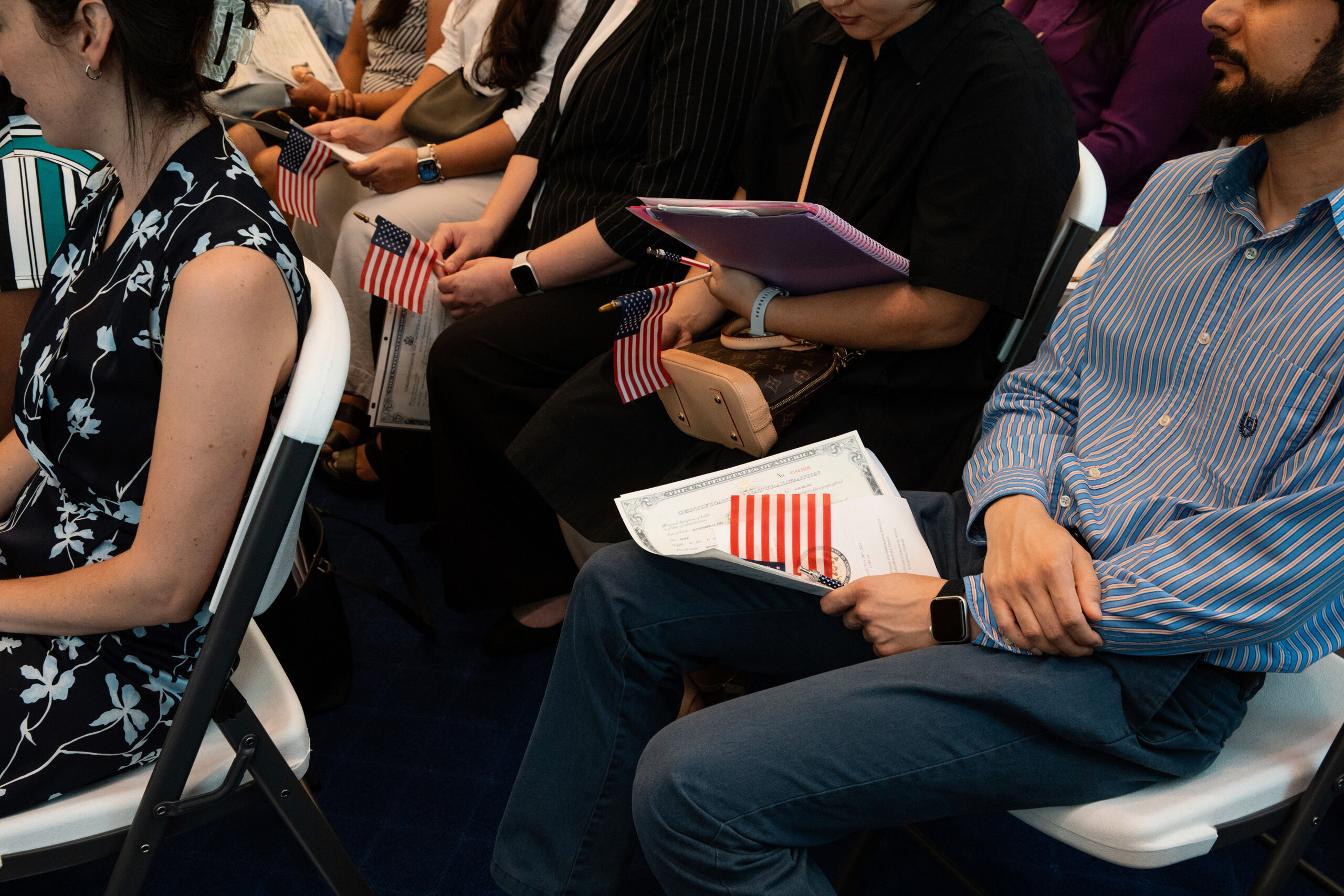 FILE — People attend a Naturalization Ceremony for new citizens in Savannah, Ga., July 29 2024. The Trump administration’s Justice Department has identified 384 foreign-born Americans whose citizenship it wants to revoke, part of a push to increase the pace of denaturalizations by assigning the cases to prosecutors in dozens of U.S. attorney’s offices across the country. (Anna Ottum/The New York Times)