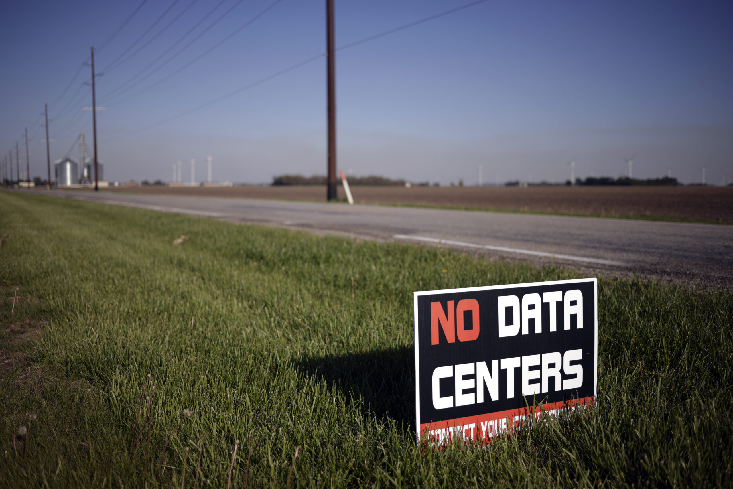 A sign expressing opposition to a proposed artificial intelligence data center at the edge of Bart and Amy SnyderÕs farm in Wolcott, Ind., on Saturday, April 25, 2026. A growing national movement against AI is pulling in people from all walks of life, united by a worry that Big Tech will cash in while average Americans bear the costs. (Luke Sharrett/The New York Times)