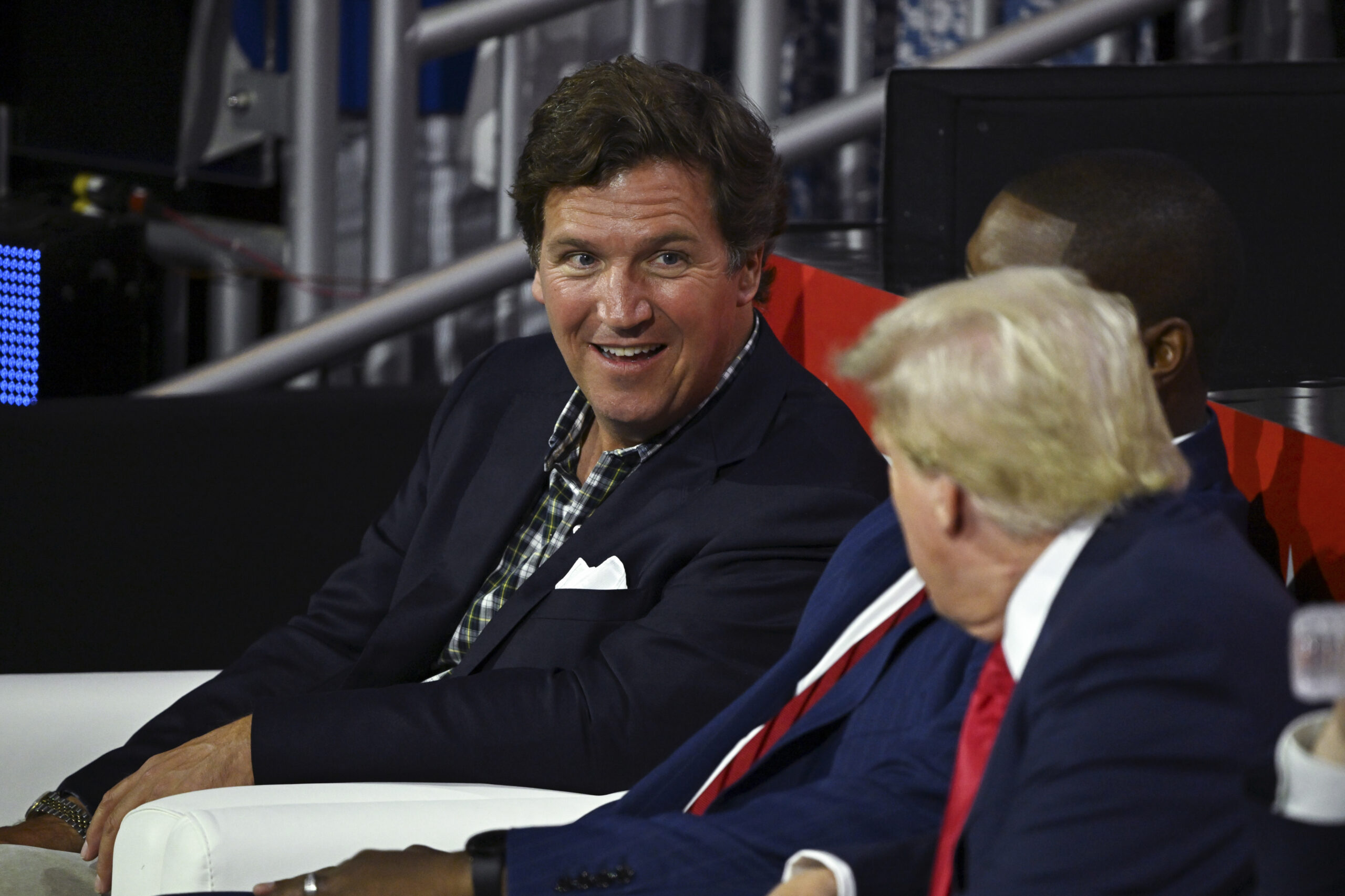 FILE — Tucker Carlson speaks with former President Donald Trump on the first day of the Republican National Convention at the Fiserv Forum in Milwaukee, July 15, 2024. Carlson, who was often at Trump’s side during the 2024 presidential campaign, is now expressing remorse for that support, saying he will long be “tormented” by his role helping Trump return to the White House. (Kenny Holston/The New York Times)