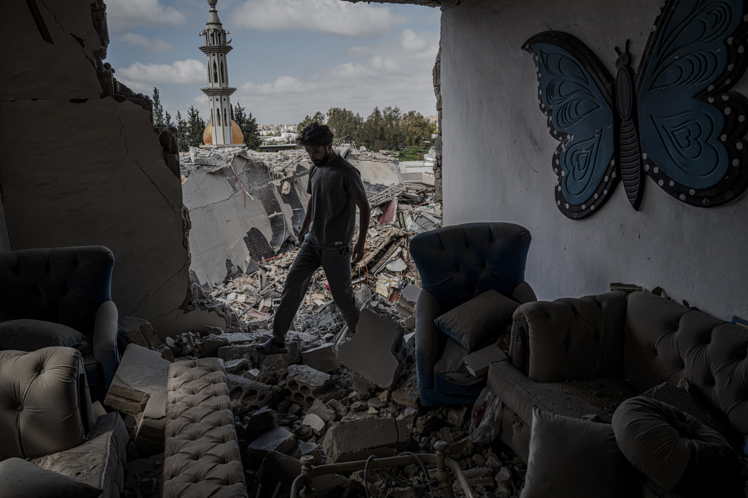 A family member assess the damage to a destroyed apartment in an apartment building in the aftermath of an Israeli airstrike in the Burj al-Shemali village near Tyre, Lebanon, on Tuesday, May 26, 2026. Israel intensified its military campaign against Hezbollah on Tuesday, striking targets across Lebanon after Prime Minister Benjamin Netanyahu said he had ordered the military to "increase the blows" against the Iran-backed militant group. (Daniel Berehulak/The New York Times)