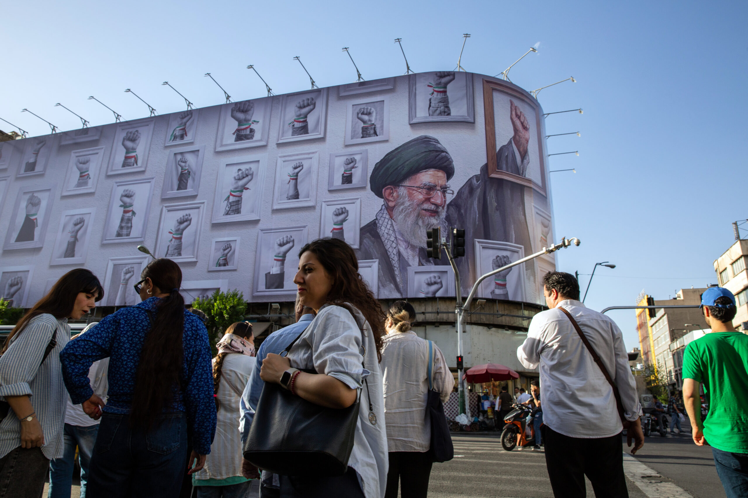 A man crosses a street near Enghelab Square in Tehran, on Sunday, May 24, 2026. The United States and Iran have agreed in principle to a deal that would wind down the war in the Middle East by reopening the Strait of Hormuz and by committing Iran to dispose of its highly enriched uranium, a senior U.S. official told reporters on Sunday. (Arash Khamooshi/Polaris for The New York Times) - CREDIT IS MANDATORY -