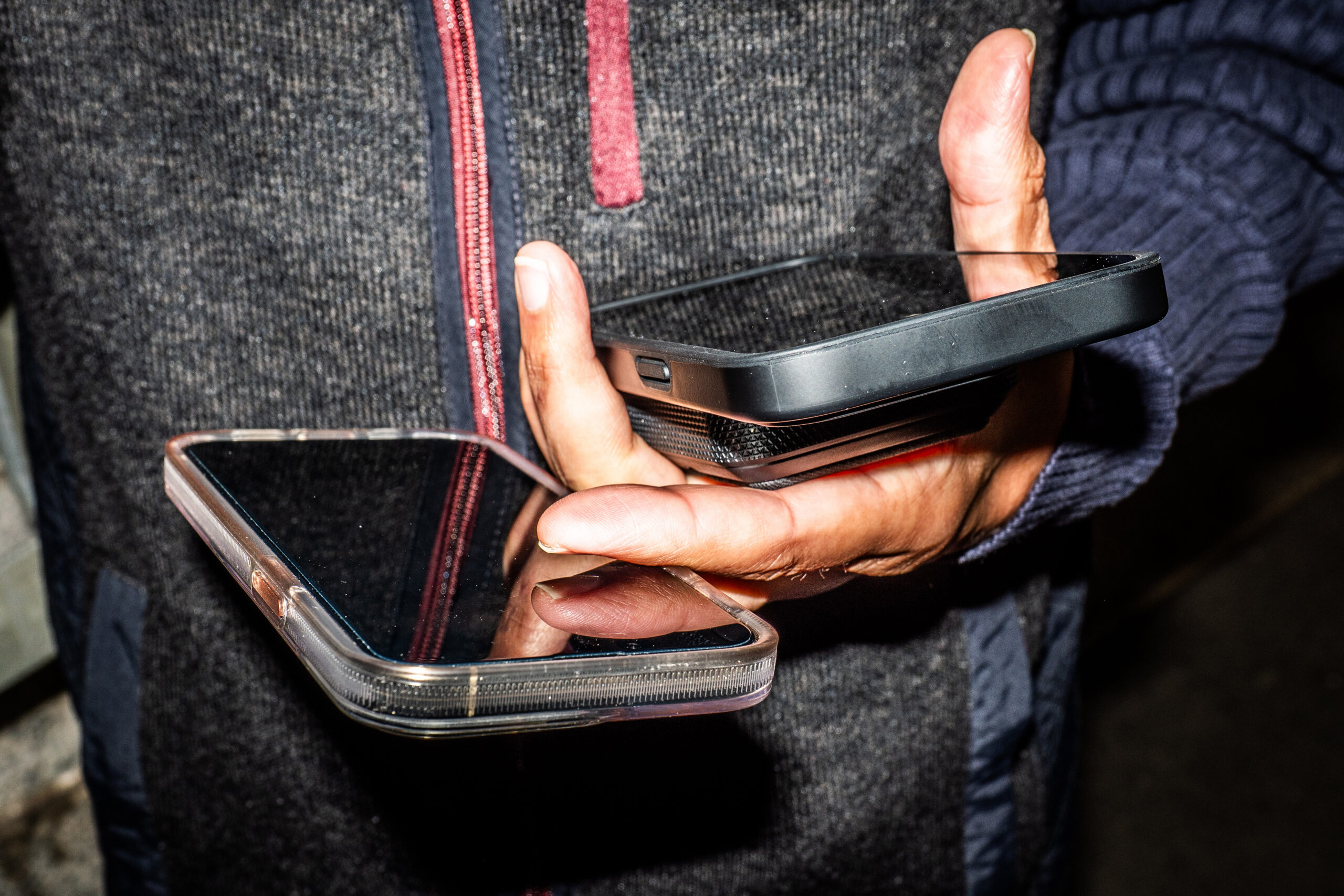 Choudhary Muhammad Kamran, 47, an entrepreneur with businesses in Dubai, New York, Singapore and Pakistan, holds two phones and a battery bank in New York, May 11, 2026. Carrying multiple cellphones, whether for cybersecurity or work-life balance, comes with some quirks and style challenges. (Graham Dickie/The New York Times)